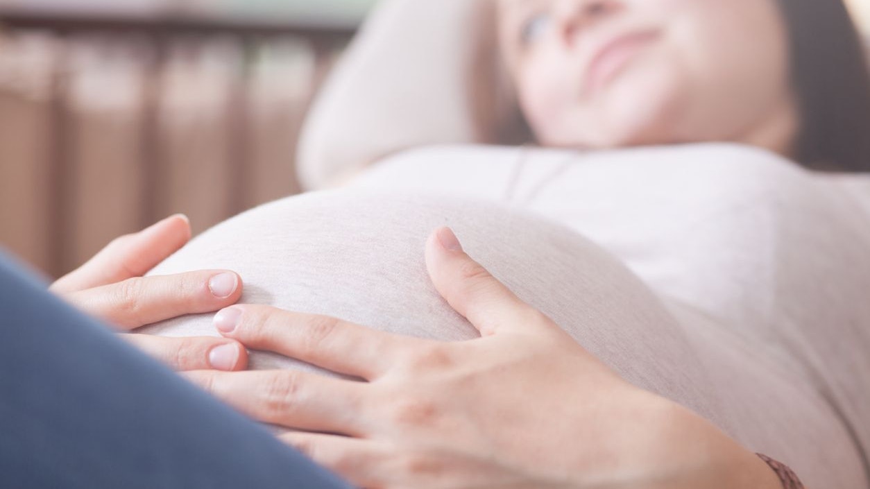 Pregnant Girl is laying in a chair and dreaming about her pregnancy.