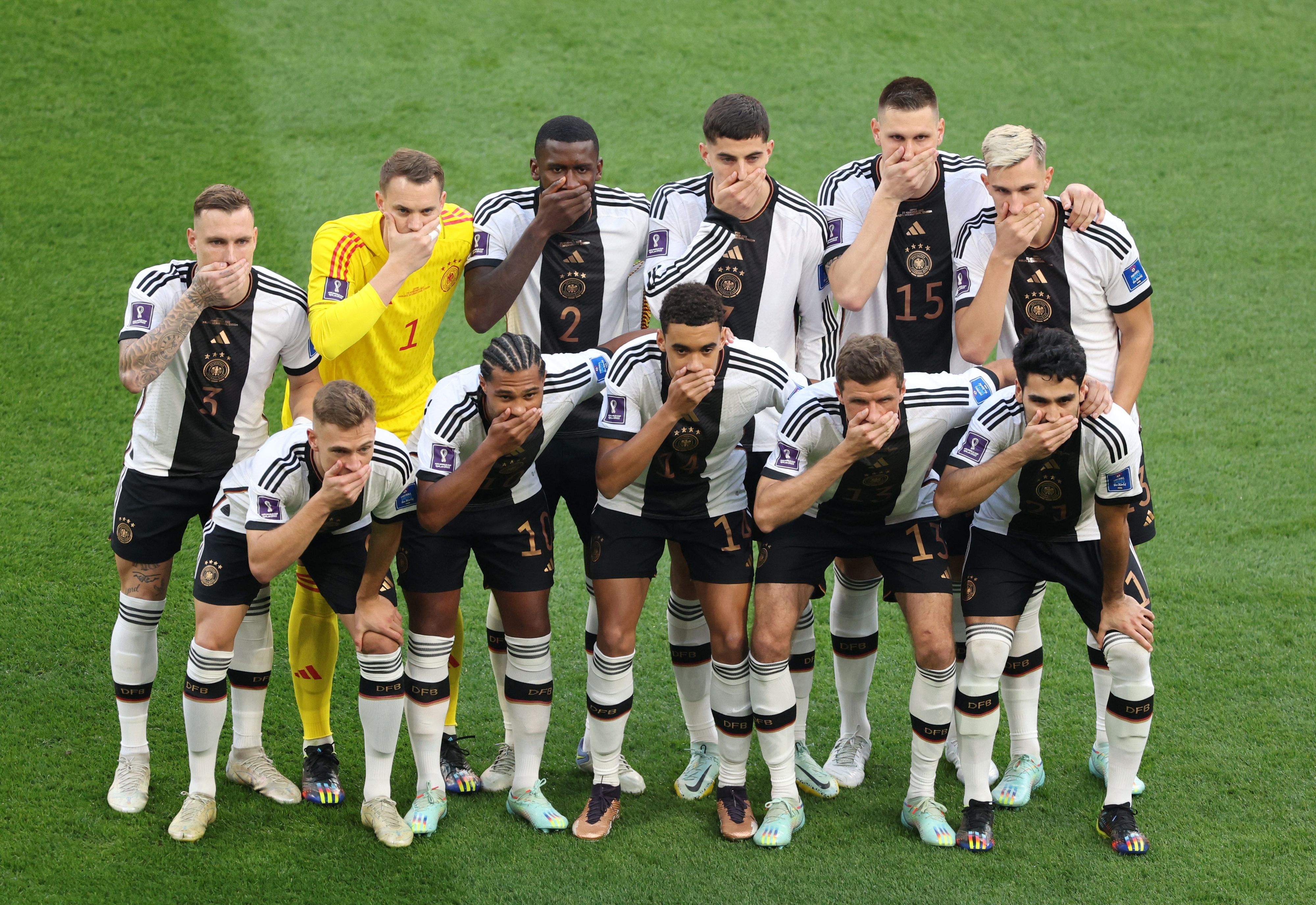 Soccer Football - FIFA World Cup Qatar 2022 - Group E - Germany v Japan - Khalifa International Stadium, Doha, Qatar - November 23, 2022 Germany players pose for a team group photo covering their mouths before the match REUTERS/Molly Darlington