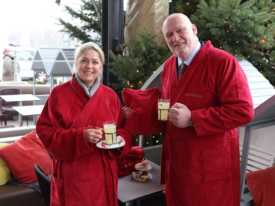 Energie sparen auf wienerisch: Das "Café Landtmann" verzichtet heuer auf Heizstrahler und bietet zusätzlich zu Punsch und Decken jetzt auch Bademäntel an. Im Bild: Sabine Pillinger (Verkaufsleiterin Vossen) mit Cafetier Berndt Querfeld.
