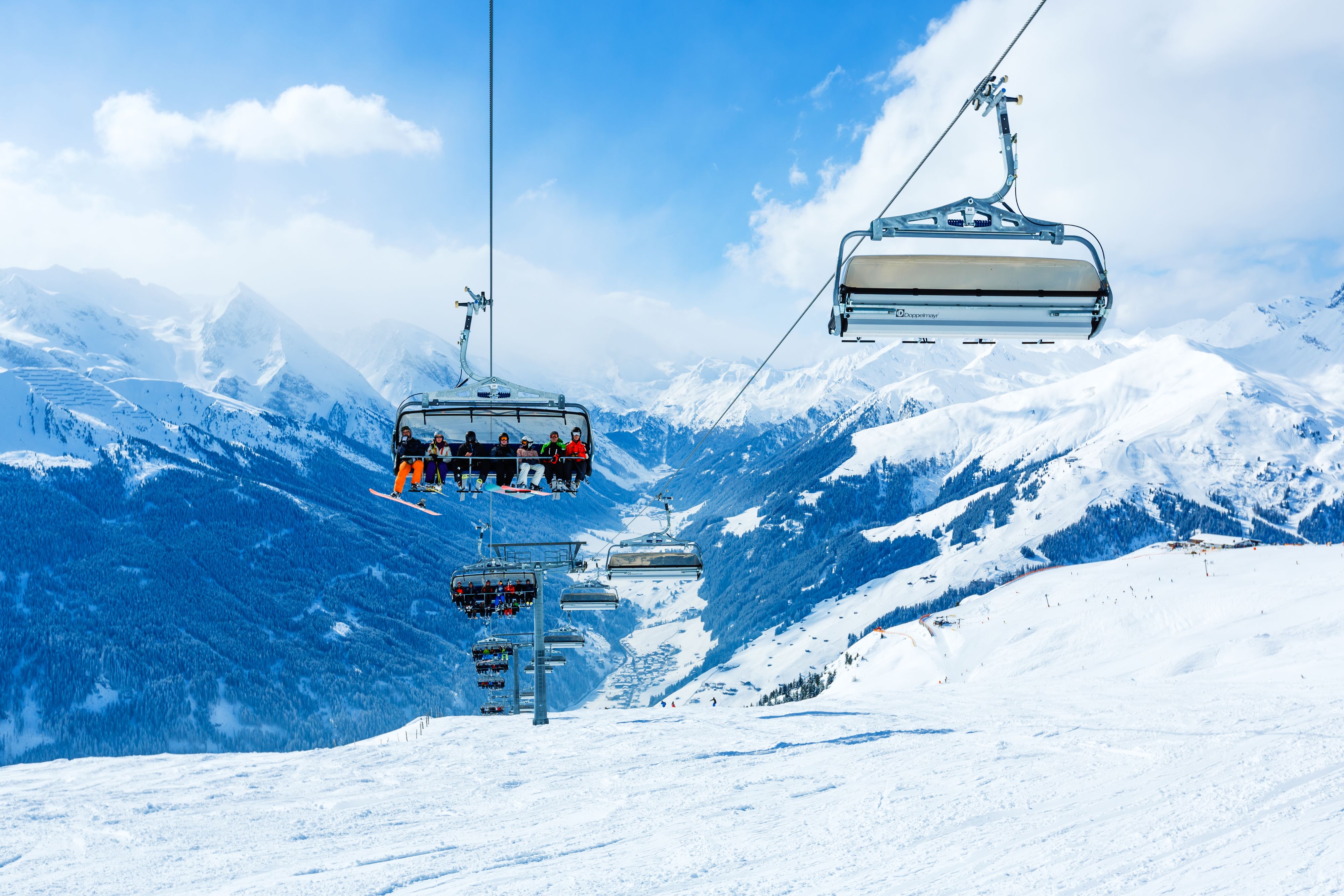 Mayrhofen, Austria - February 25, 2013: Skiers on way up on 8-seater chairlift at winter ski resort Mayrhofen, Tirol, Austria.