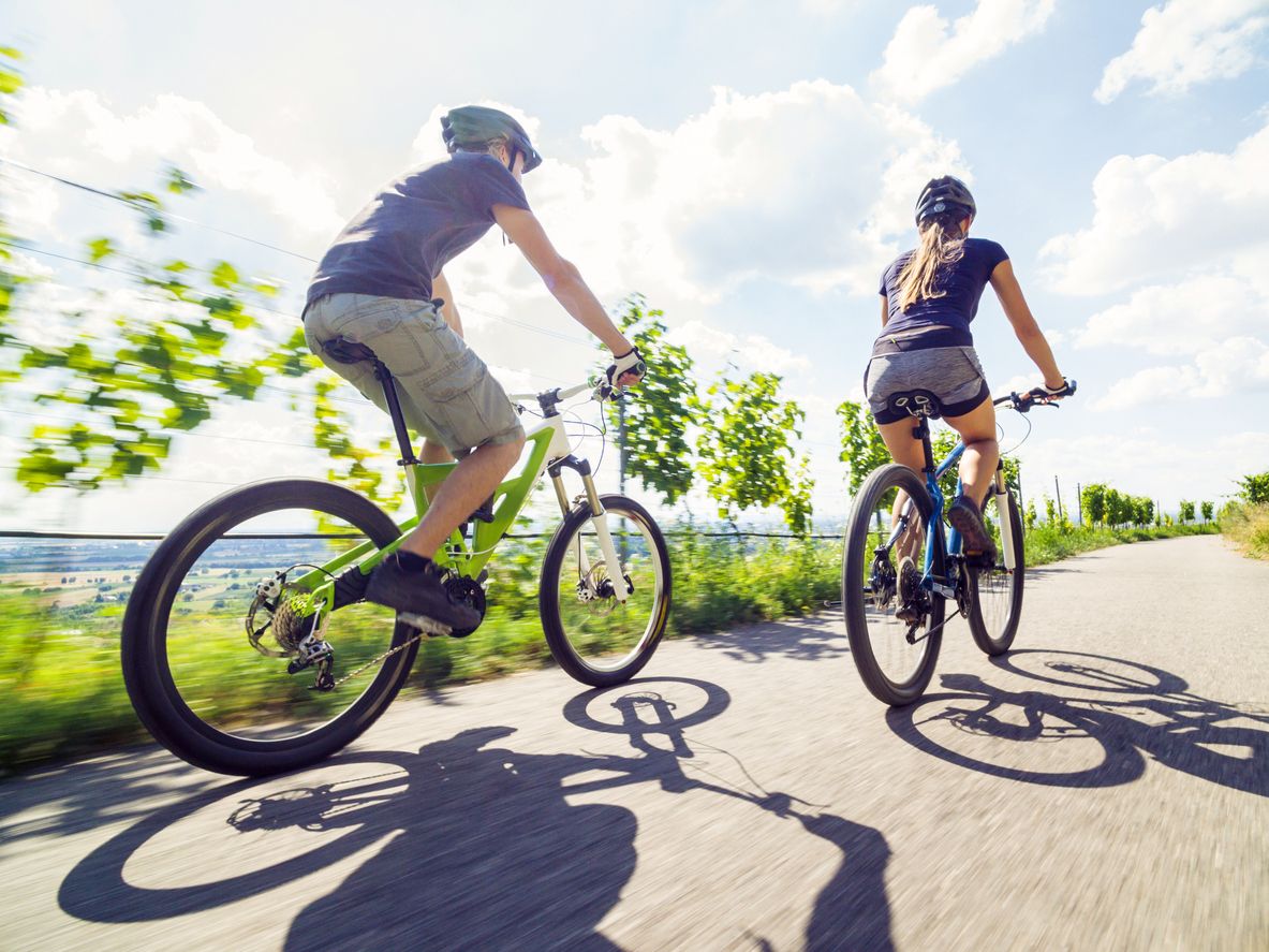 Young couple riding their mountain bikes