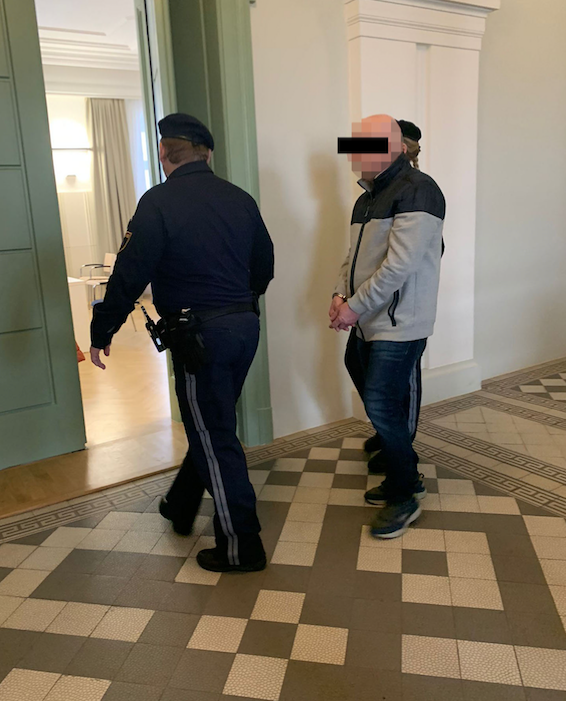 Der Angeklagte in Handschellen vor dem Gerichtssaal in St. Pölten.