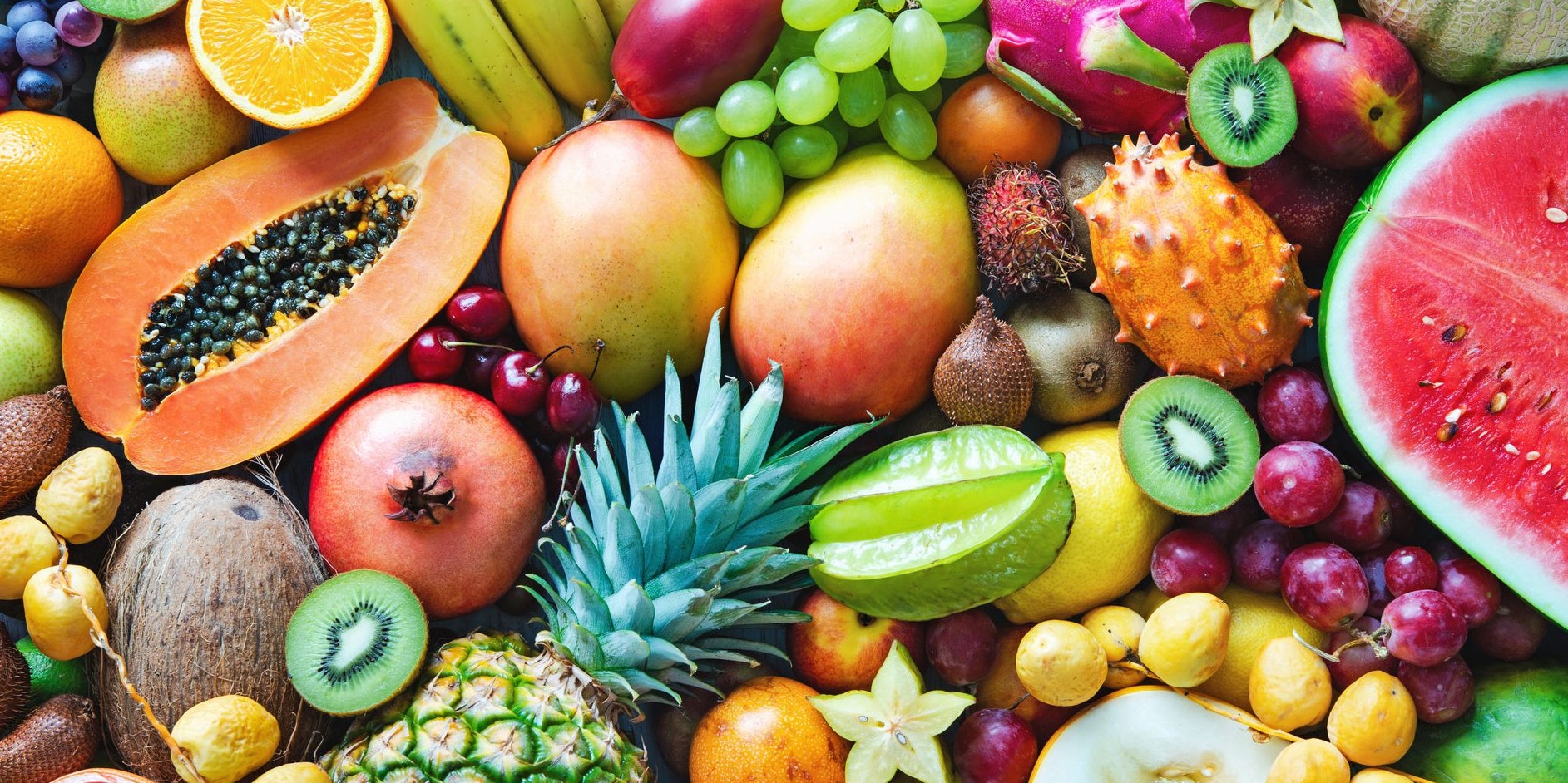 Food background. Assortment of colorful ripe tropical fruits. Top view