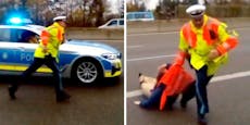 Video: Polizist reißt Klima-Kleberin von der Autobahn