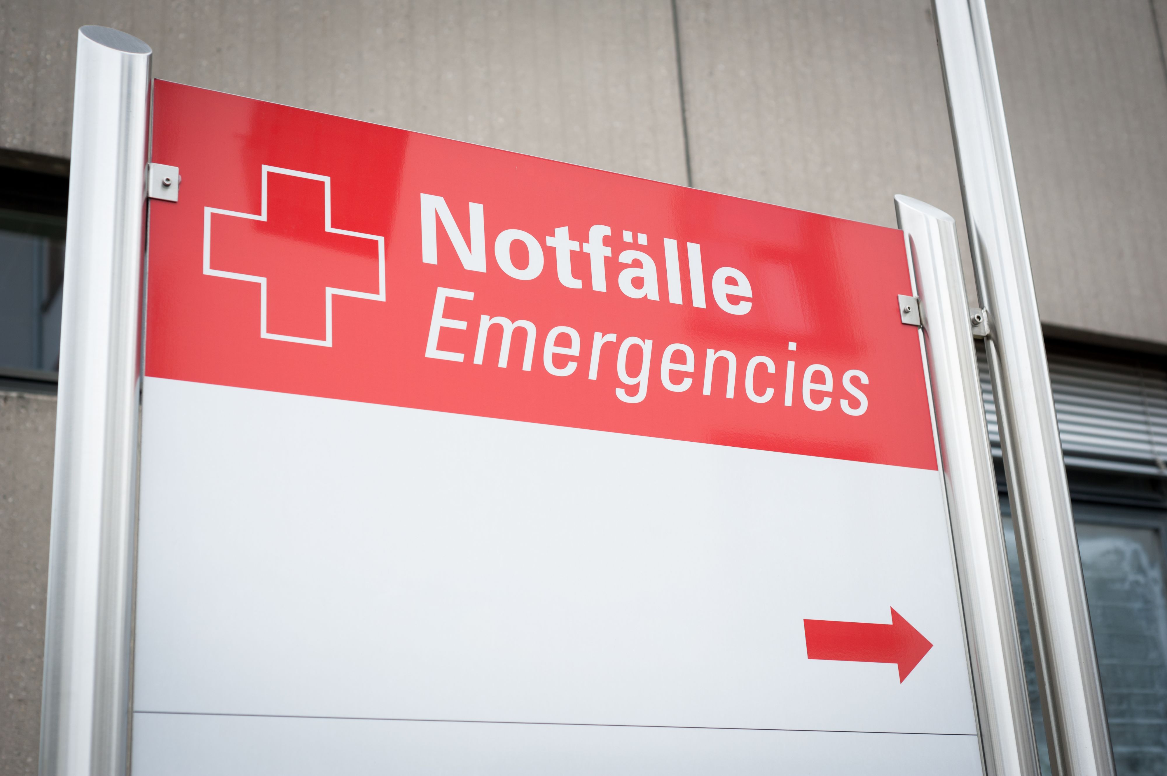 A sign reading in German "Notfaelle" (Emergencies) - showing the way to the emergency room. Red arrow and copy space
