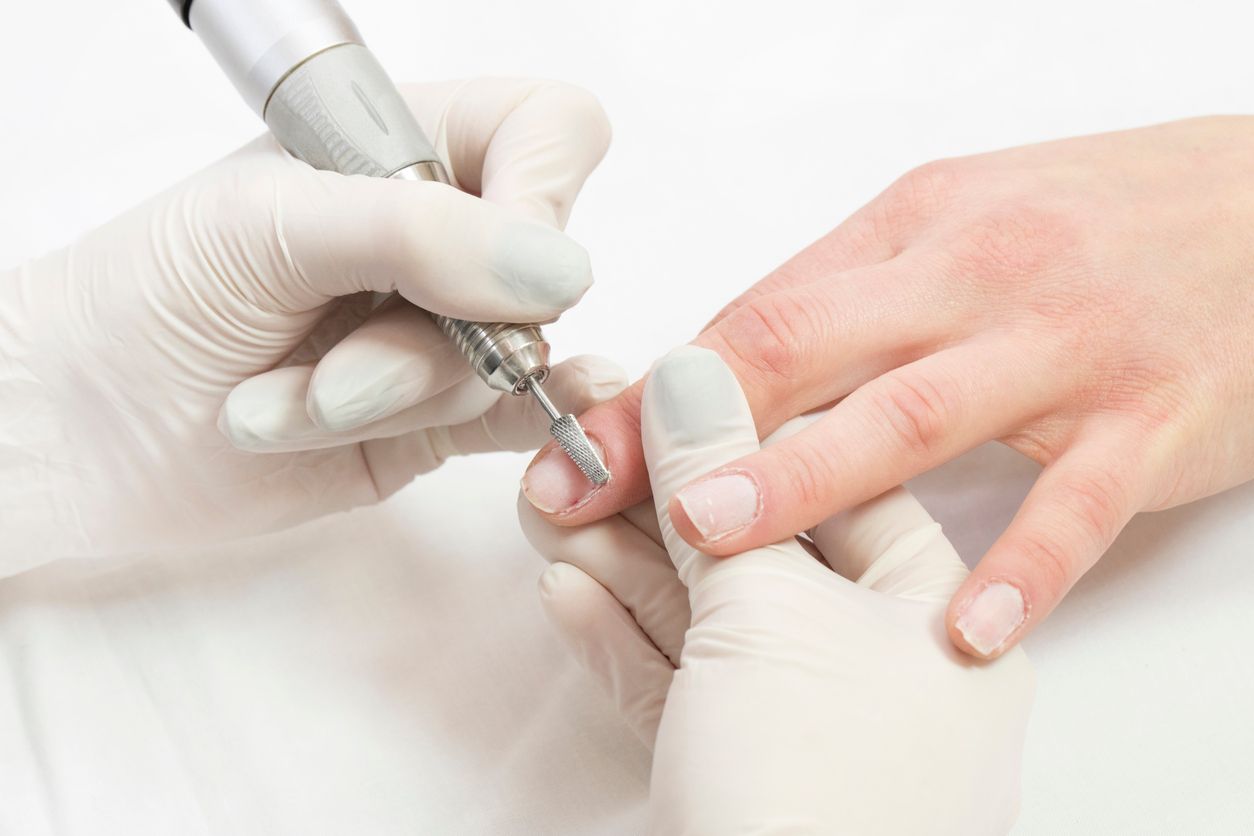 Female hand manicure procedure shot in closeup in a beauty salon.