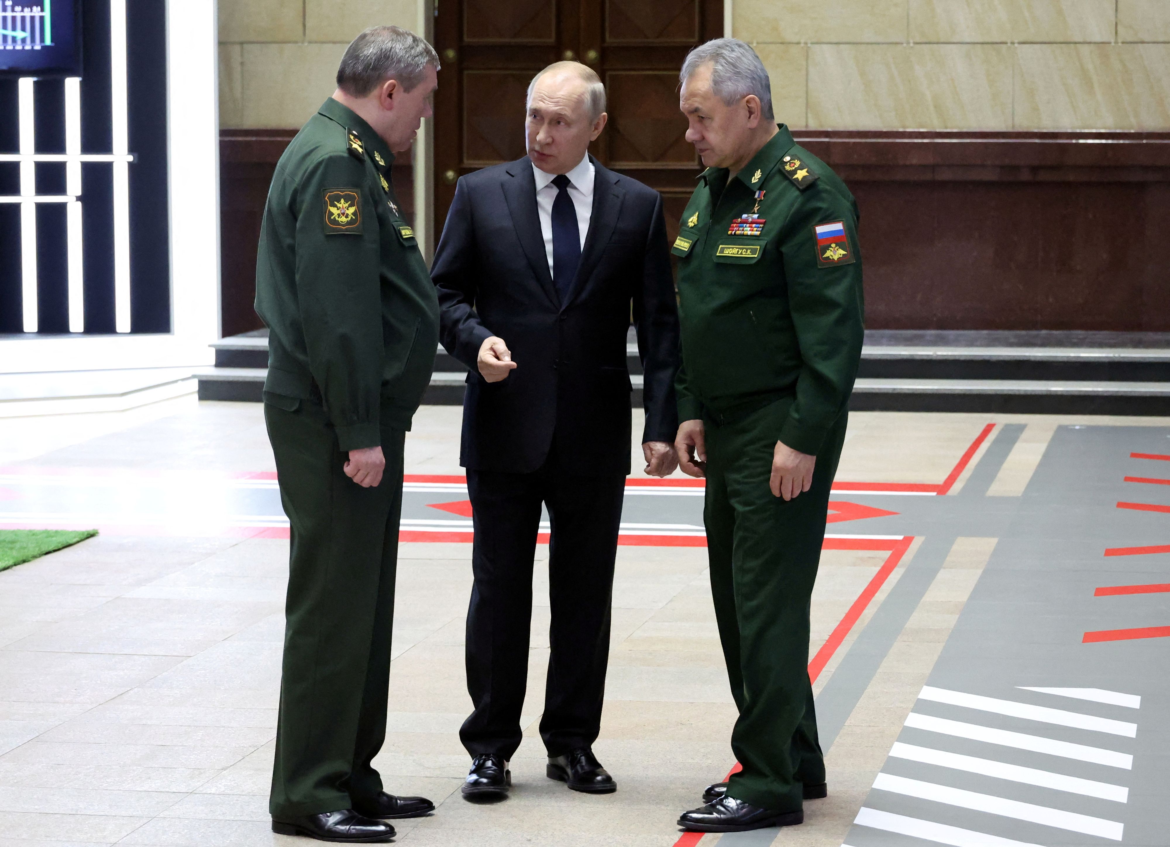 Russian President Vladimir Putin, Defence Minister Sergei Shoigu and Chief of the General Staff of Russian Armed Forces Valery Gerasimov speak after a meeting of the Defence Ministry Board in Moscow, Russia, December 21, 2022. Sputnik/Mikhail Klimentyev/Kremlin via REUTERS ATTENTION EDITORS - THIS IMAGE WAS PROVIDED BY A THIRD PARTY.