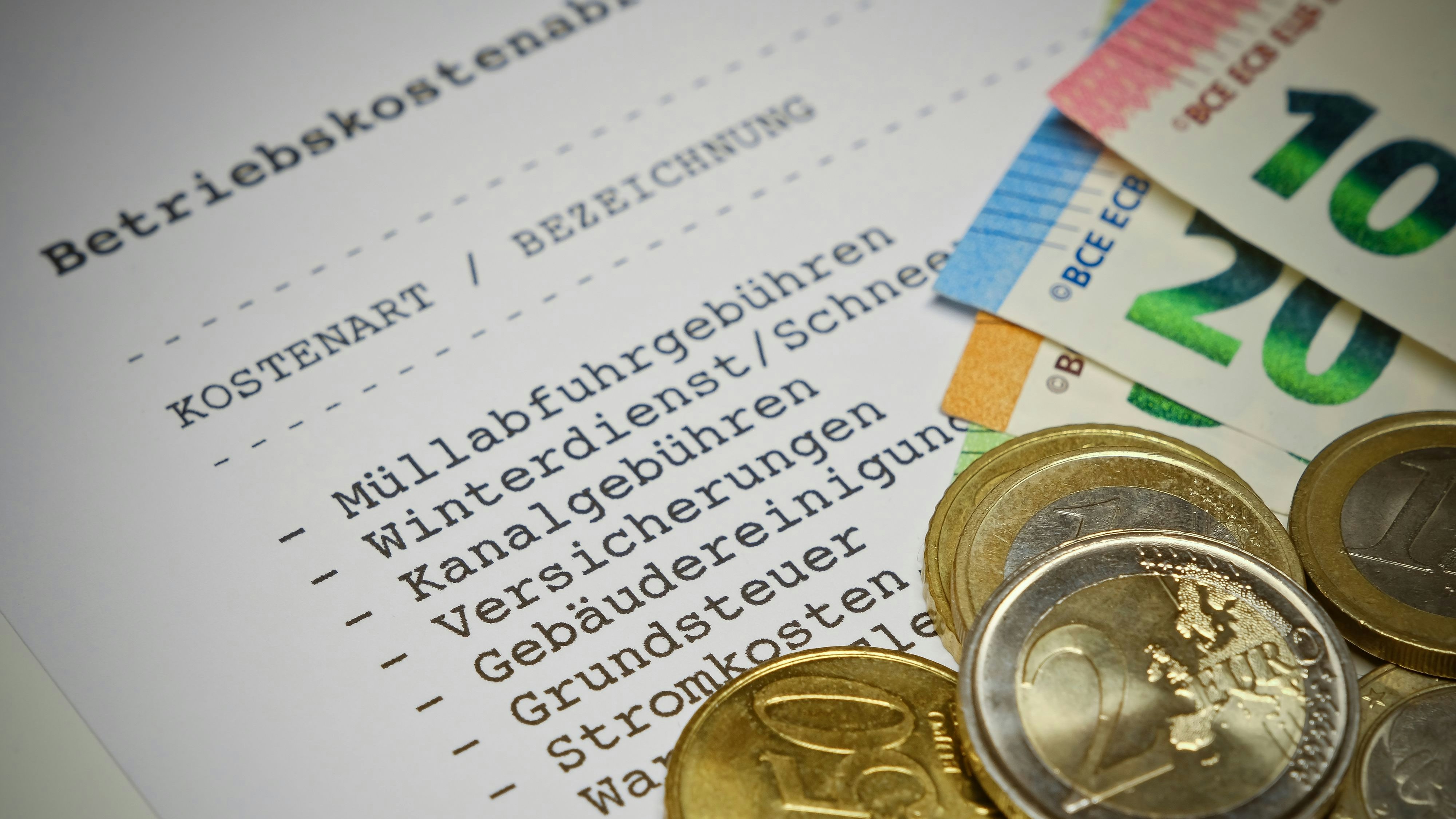Betriebskostenabrechnung (german language) - Statement of operating costs with Euro coins and Euro banknotes. Information: The statement has been designed and printed by myself. No problems with copyright.