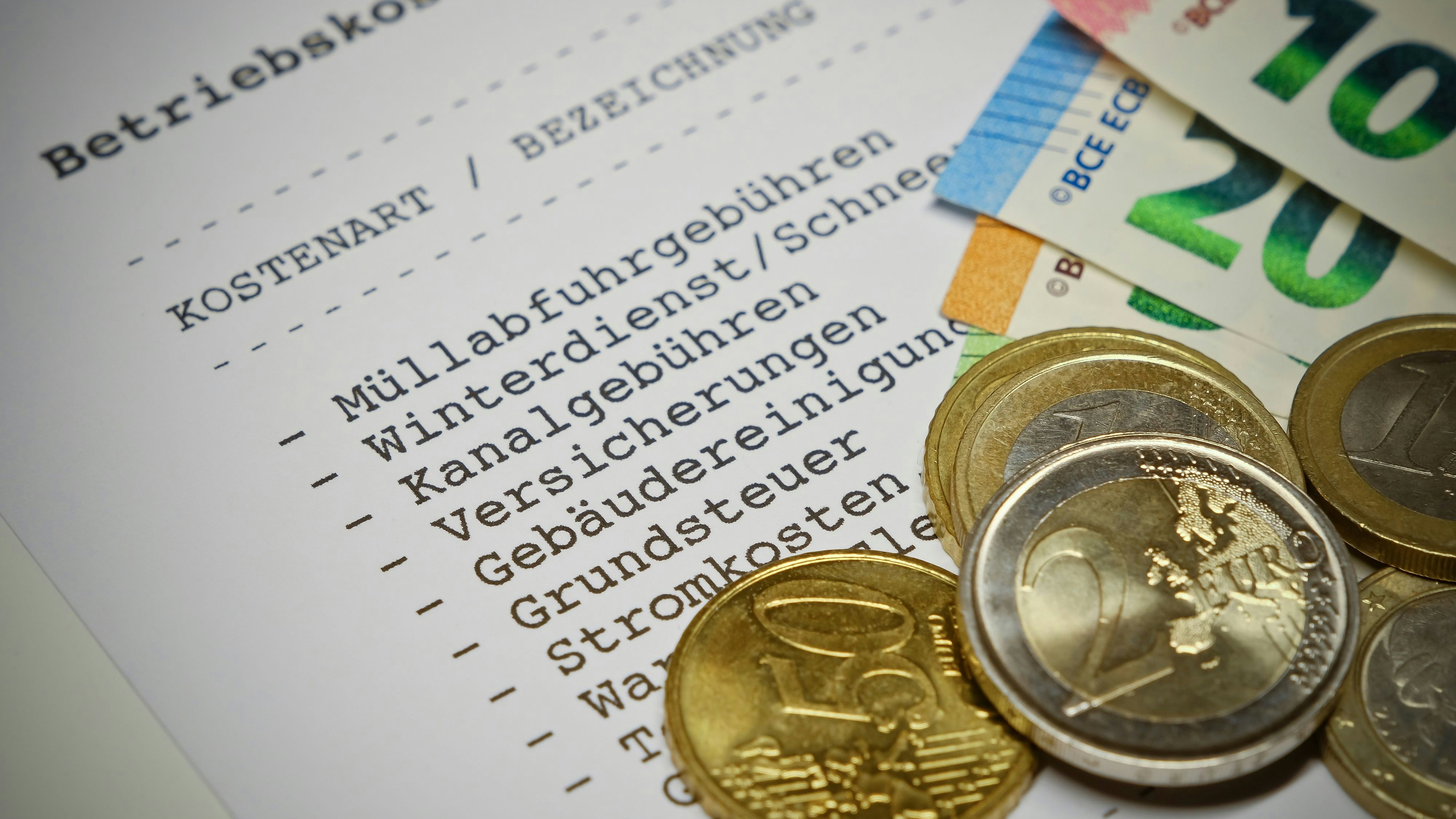 Betriebskostenabrechnung (german language) - Statement of operating costs with Euro coins and Euro banknotes. Information: The statement has been designed and printed by myself. No problems with copyright.