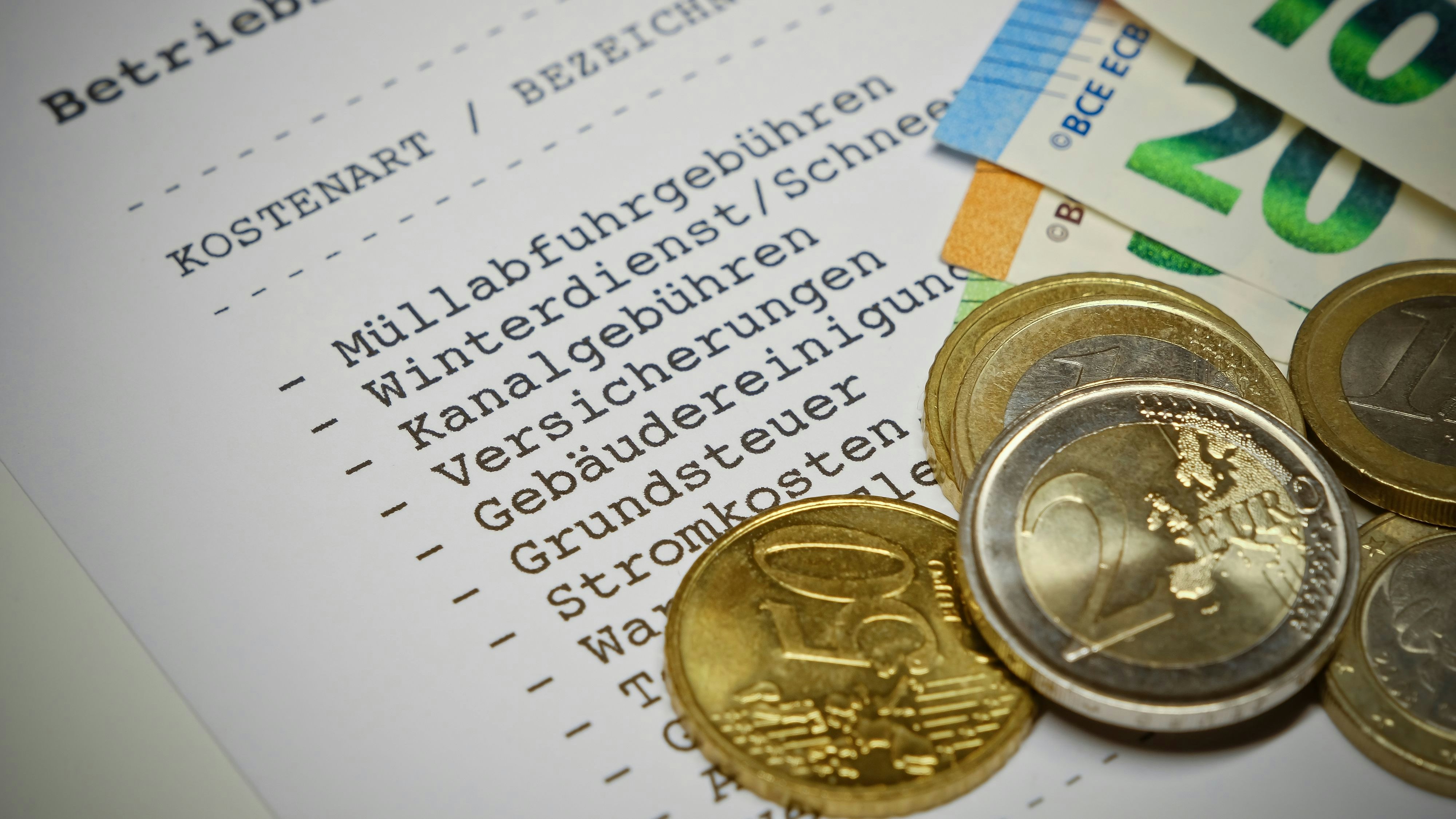 Betriebskostenabrechnung (german language) - Statement of operating costs with Euro coins and Euro banknotes. Information: The statement has been designed and printed by myself. No problems with copyright.