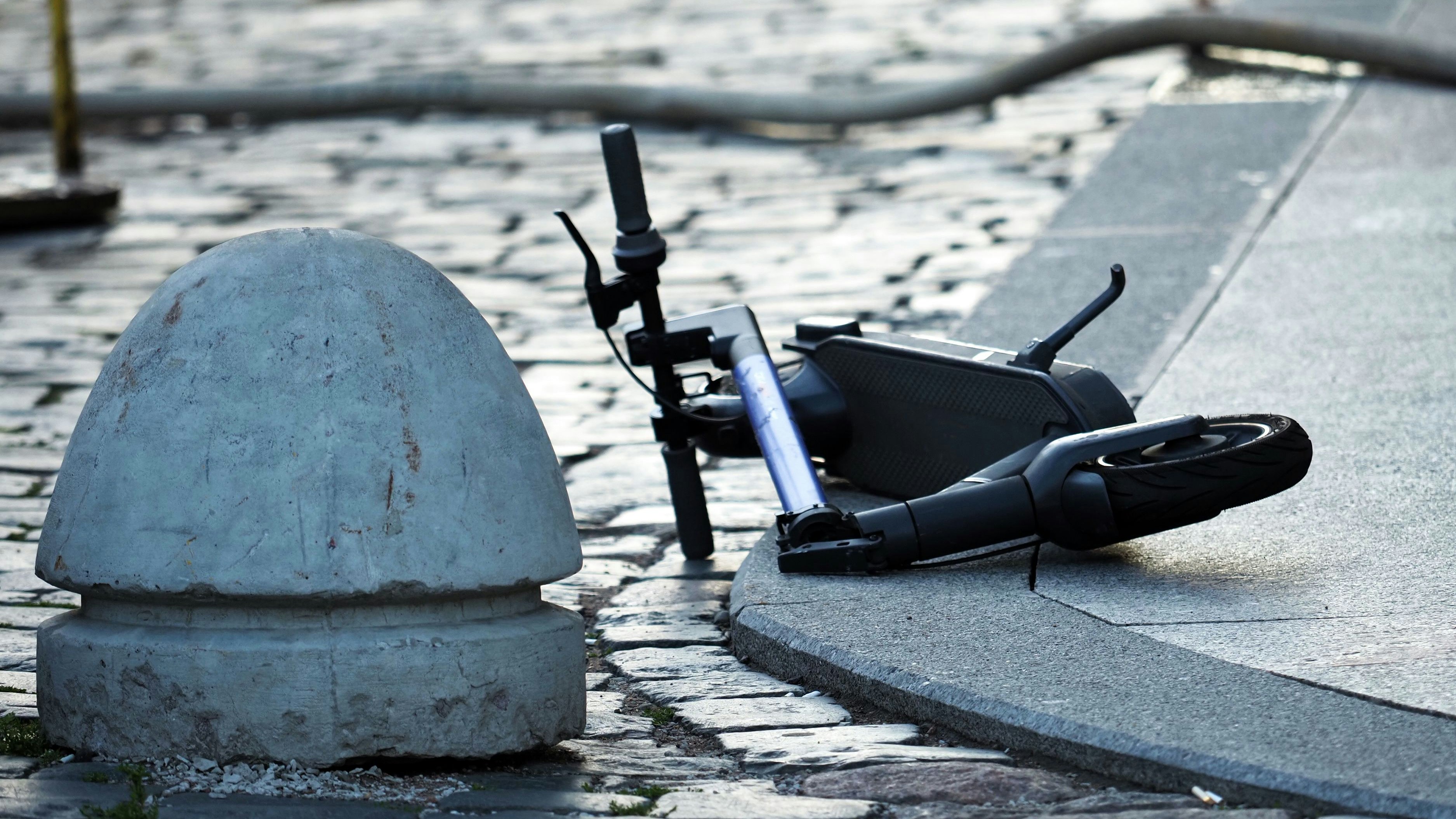 Broken scooter on the road after an accident