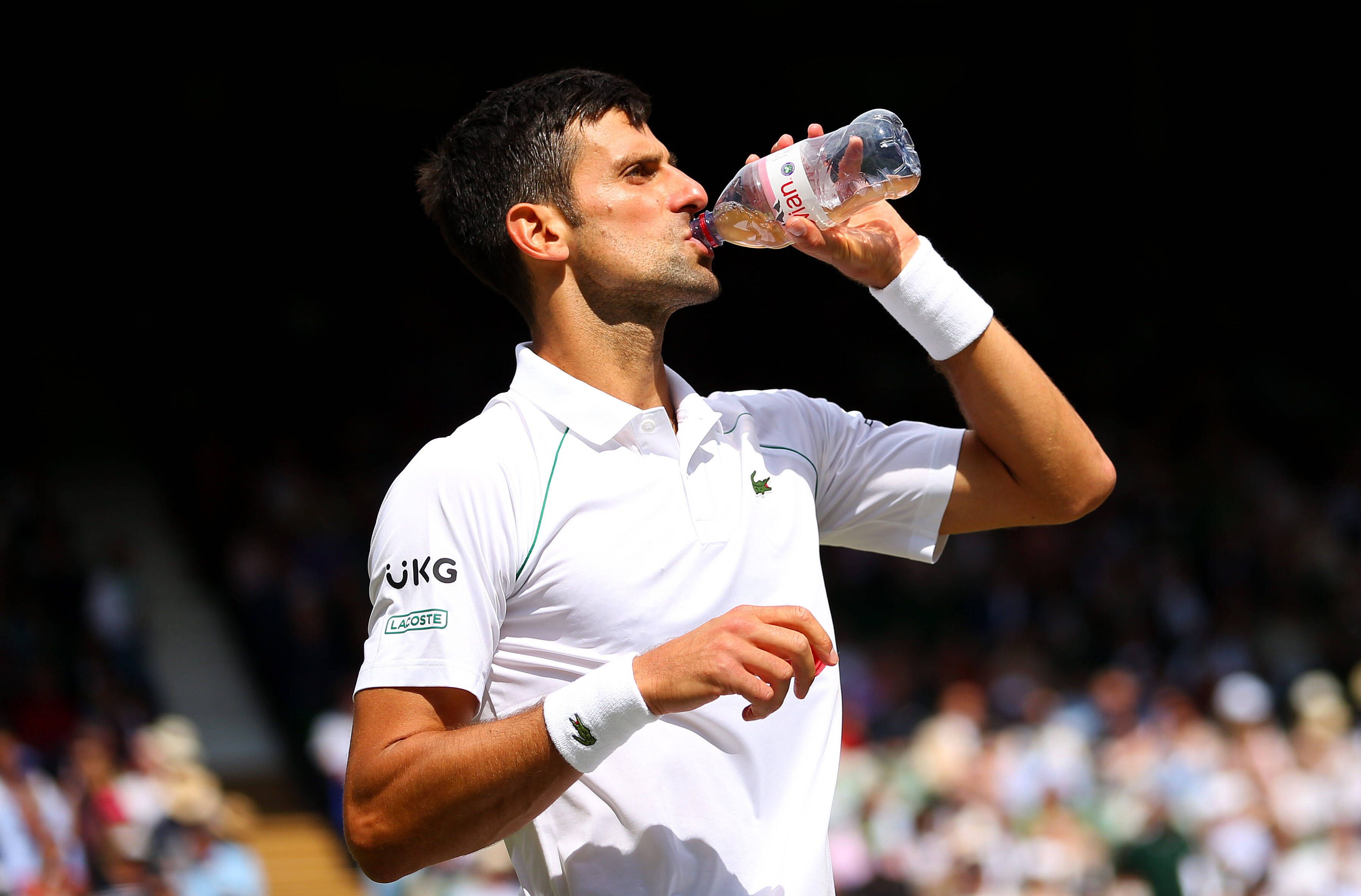 Mandatory Credit: Photo by Shutterstock 12204580d Novak Djokovic of Serbia drinks evian water Wimbledon Tennis Championships, Day 13, The All England Lawn Tennis and Croquet Club, London, UK - 11 Jul 2021 Wimbledon Tennis Championships, Day 13, The All England Lawn Tennis and Croquet Club, London, UK - 11 Jul 2021 PUBLICATIONxINxGERxSUIxAUTXHUNxGRExMLTxCYPxROMxBULxUAExKSAxONLY Copyright: xShutterstockx 12204580d 