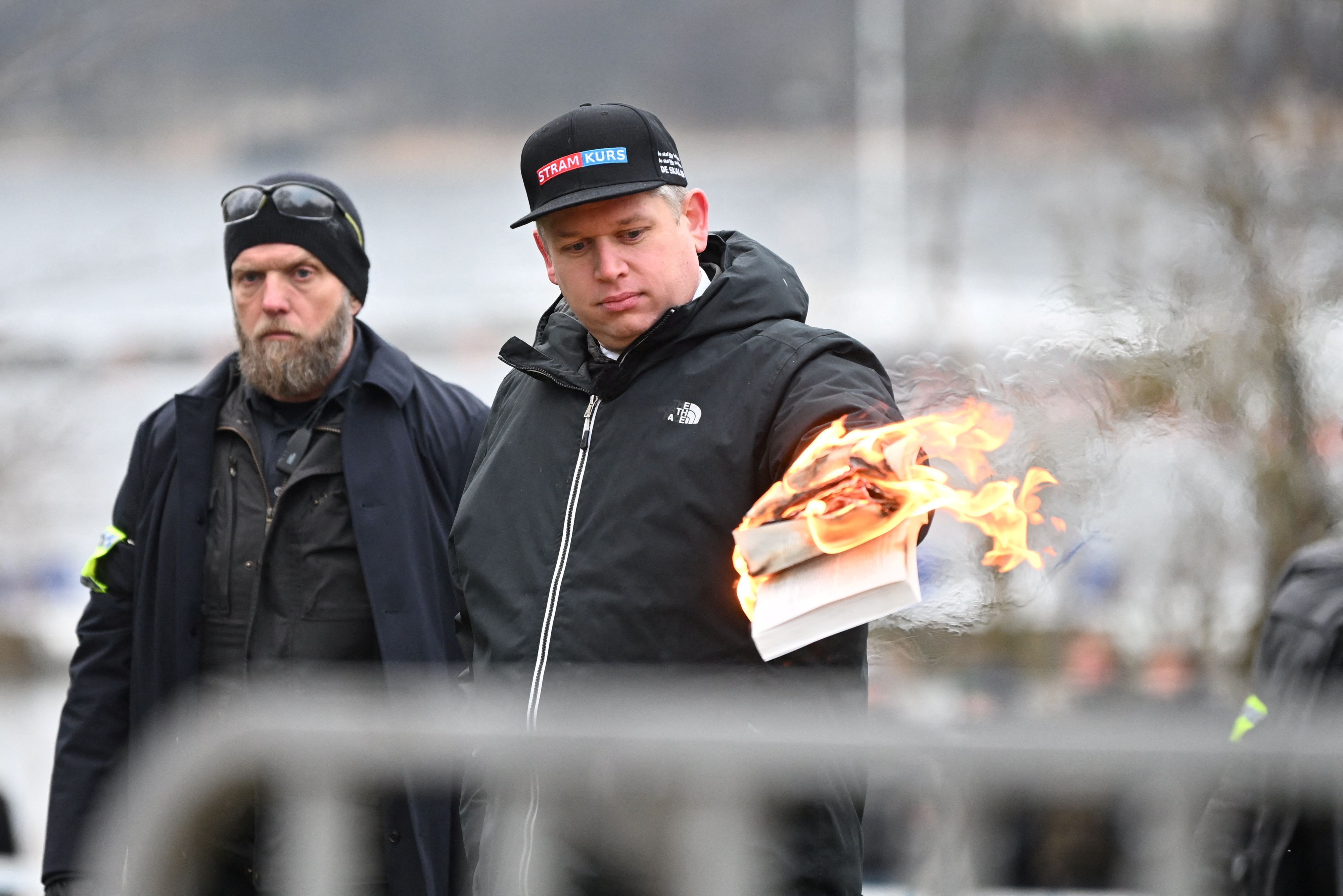 Leader of the far-right Danish political party Stram Kurs Rasmus Paludan burns a copy of the Koran during a manifestation outside the Turkish embassy in Stockholm, Sweden,  January 21, 2023. Fredrik Sandberg/TT News Agency/via REUTERS      ATTENTION EDITORS - THIS IMAGE WAS PROVIDED BY A THIRD PARTY. SWEDEN OUT. NO COMMERCIAL OR EDITORIAL SALES IN SWEDEN.