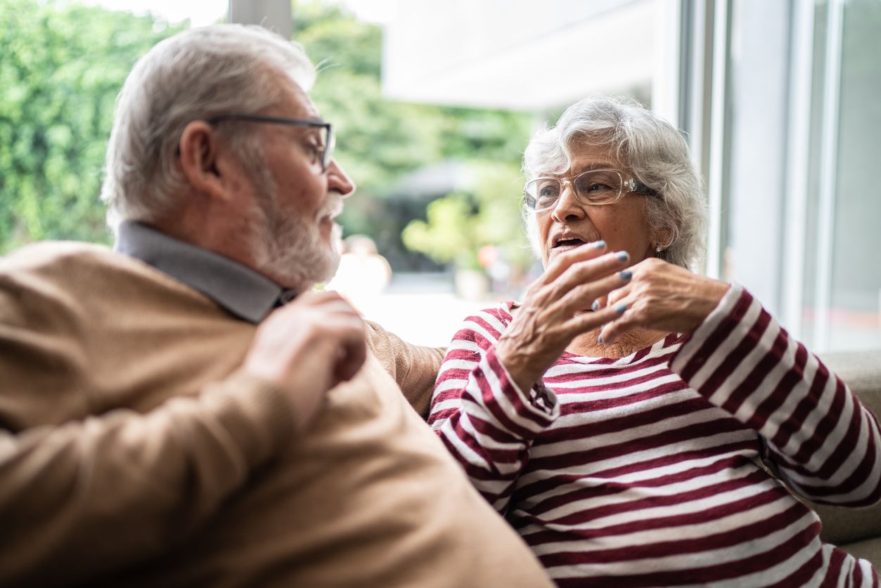 Senior couple discussing at home