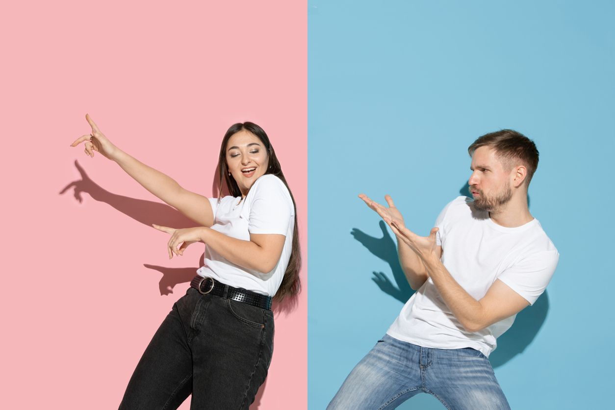 Romantic. Dancing, moving, having fun. Young and happy man and woman in casual clothes on pink, blue bicolored background. Concept of human emotions, facial expession, relations, ad. Beautiful couple.