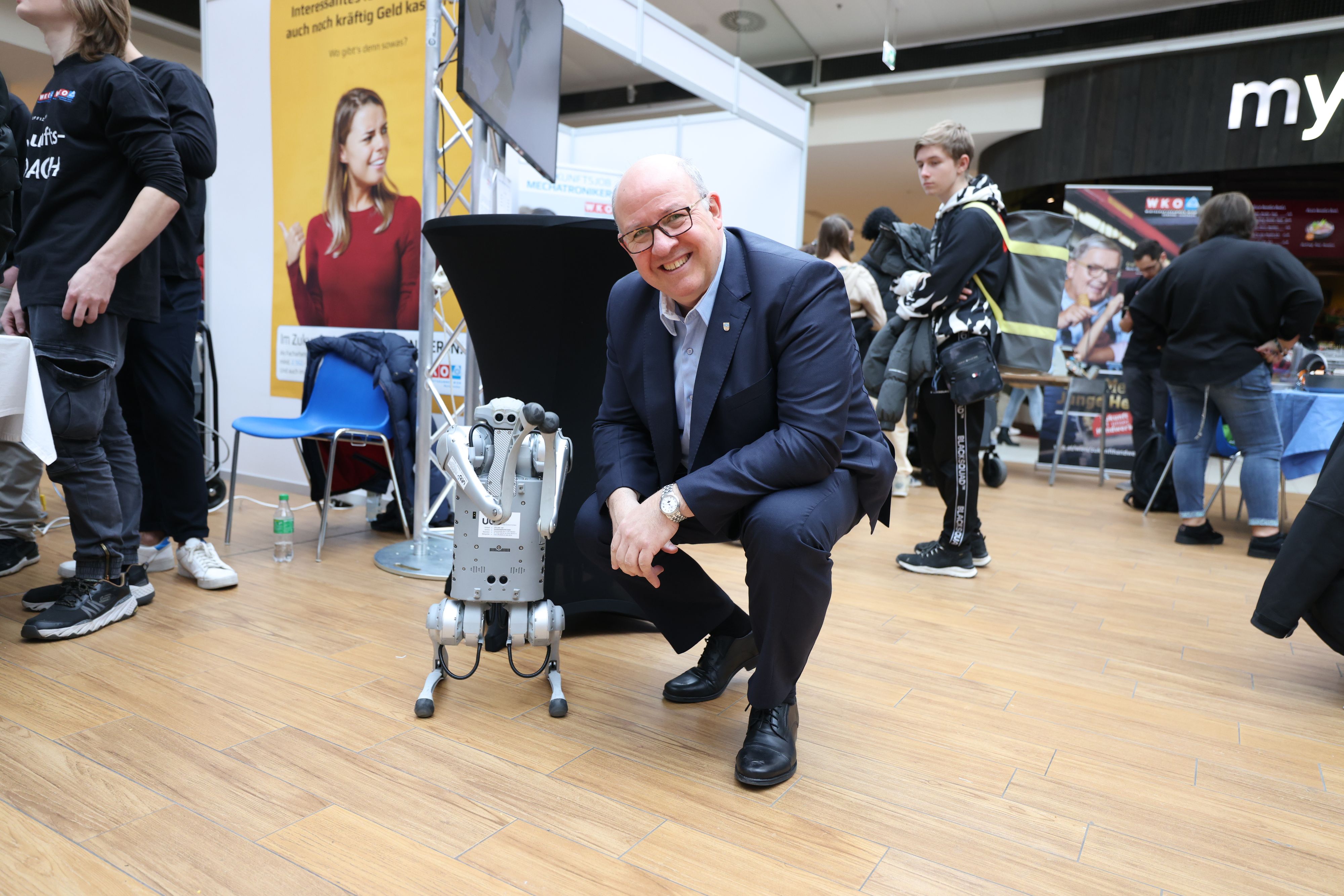 Innungsmeister der Mechatroniker, Peter Merten, mit dem Roboterhund, einer Attraktion des Events.