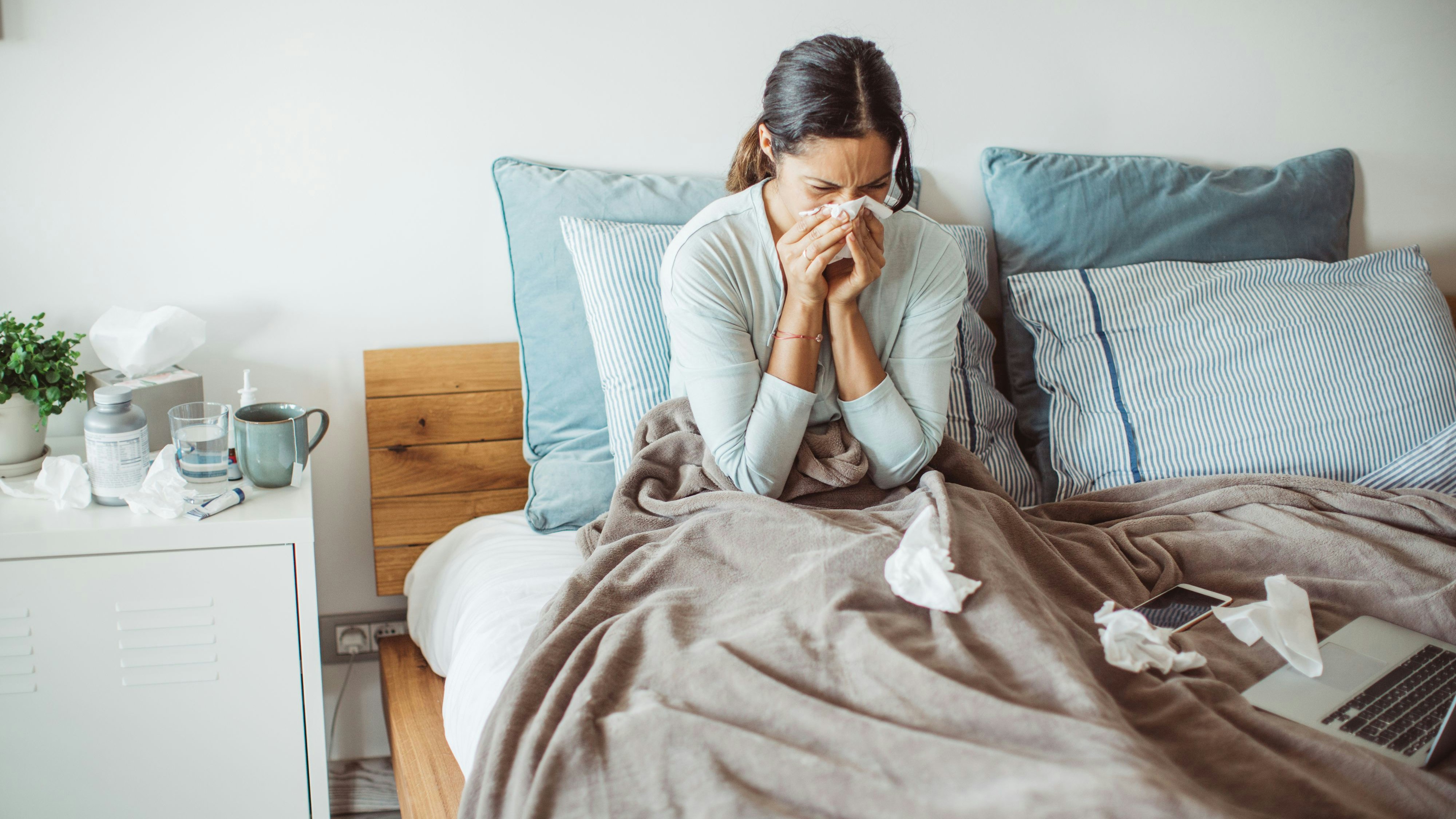 Woman with flu in bed, she use home medicine to handle sickness