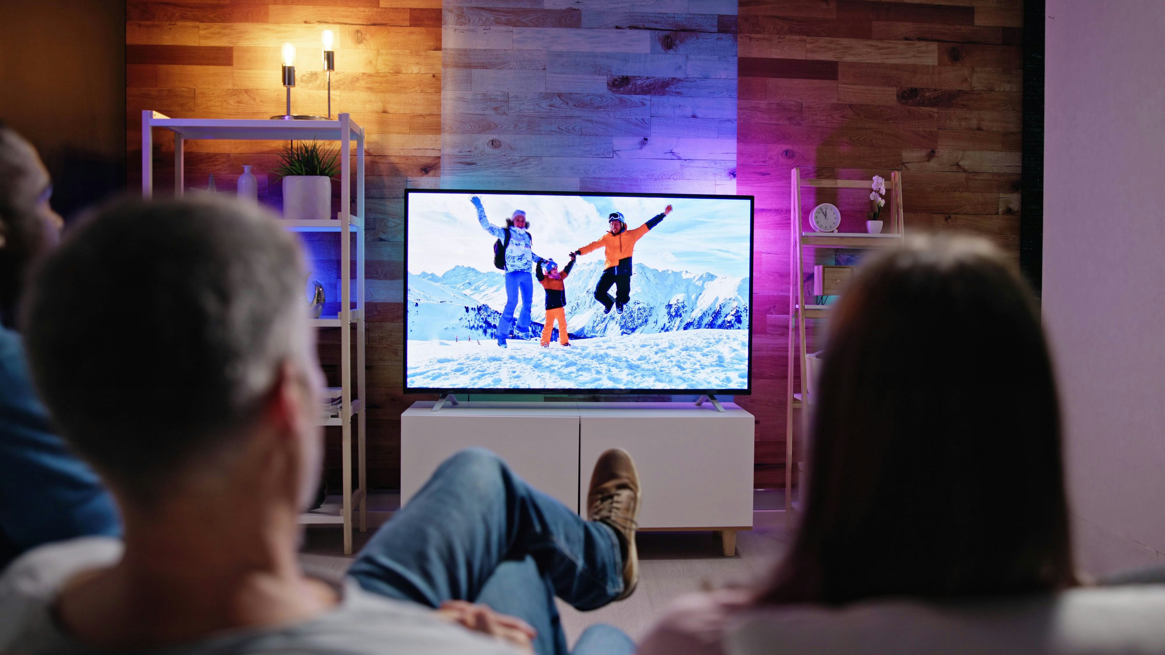 African Family Watching TV Movie On Television