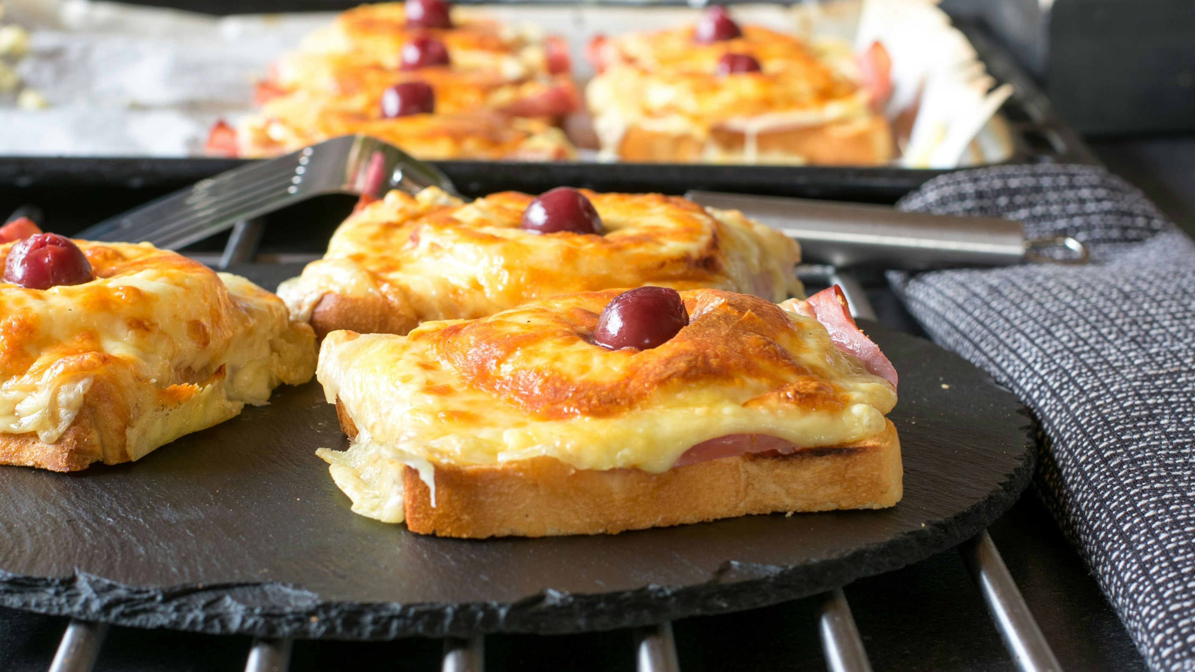 gratinated Toast Hawaii with ham, cheese, pineapple and cherry. Close up