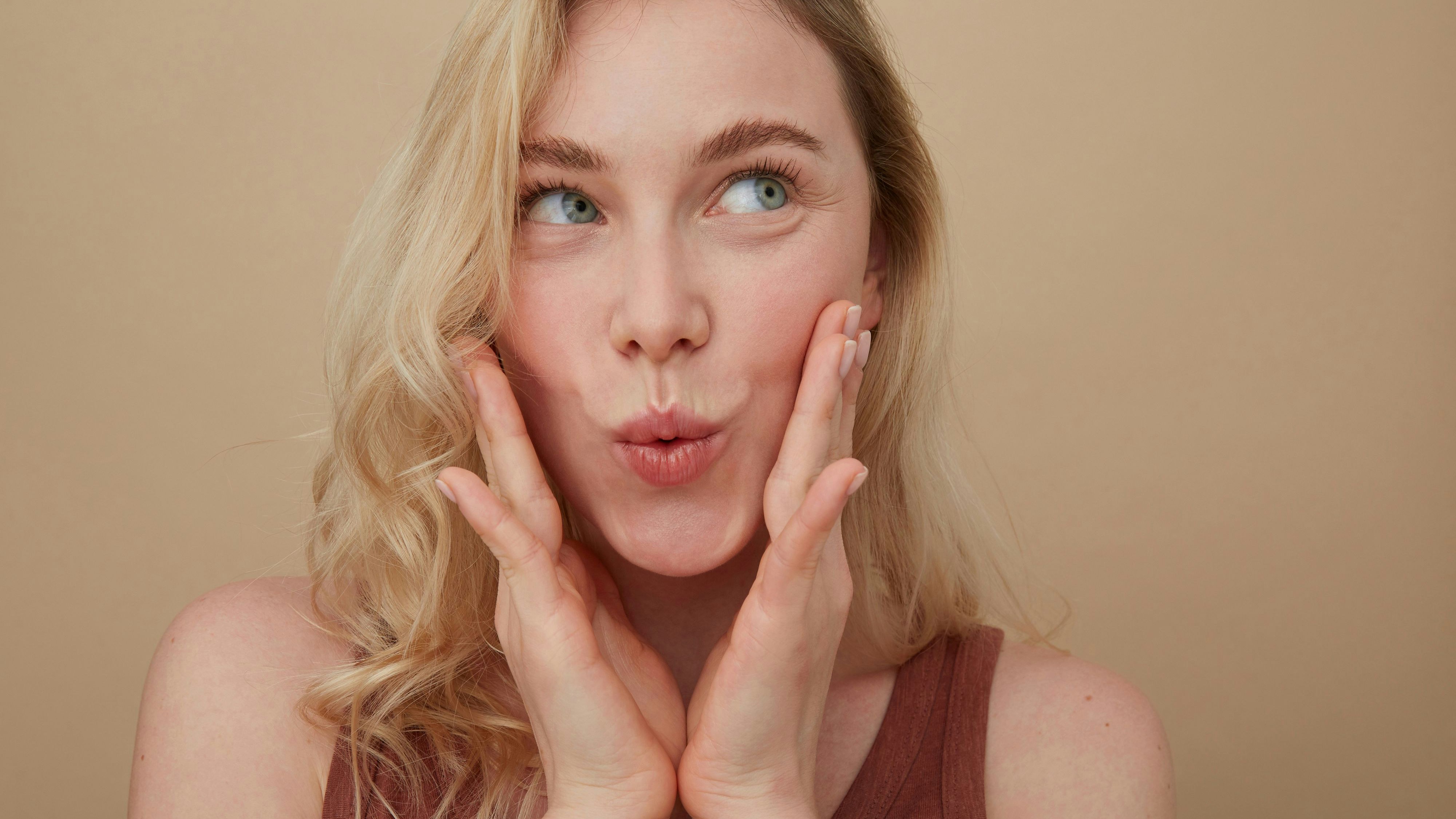 Portrait of young blond woman pouting mouth