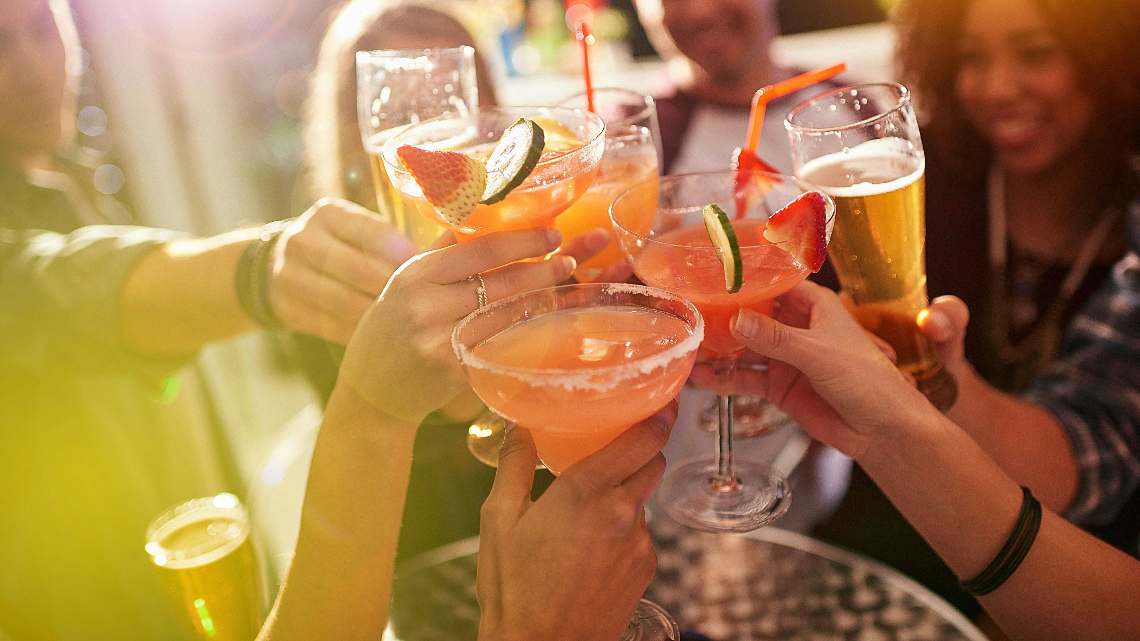 Shot of a group of people toasting with their drinks at a nightclub