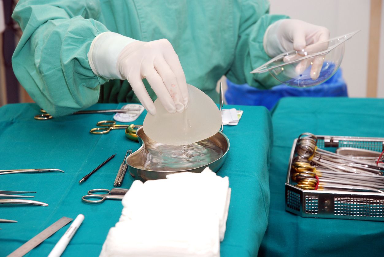 nurse prepares implant for surgery