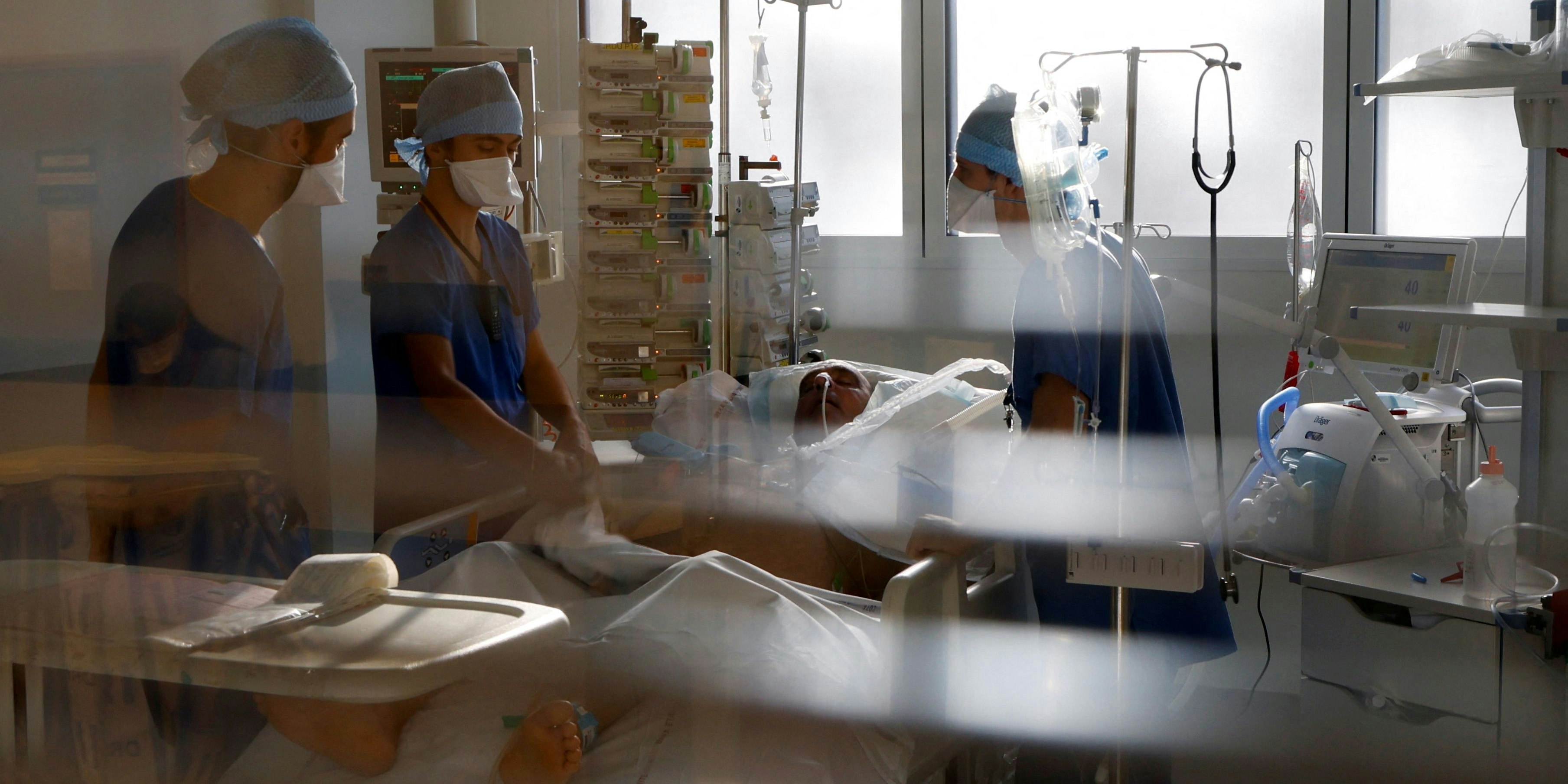 Medical staff members work in the Intensive Care Unit (ICU) for COVID-19 patients at La Timone hospital in Marseille, as France is seeing an increase in coronavirus disease (COVID-19) cases and hospitalisations, France, December 10, 2021. REUTERS/Eric Gaillard