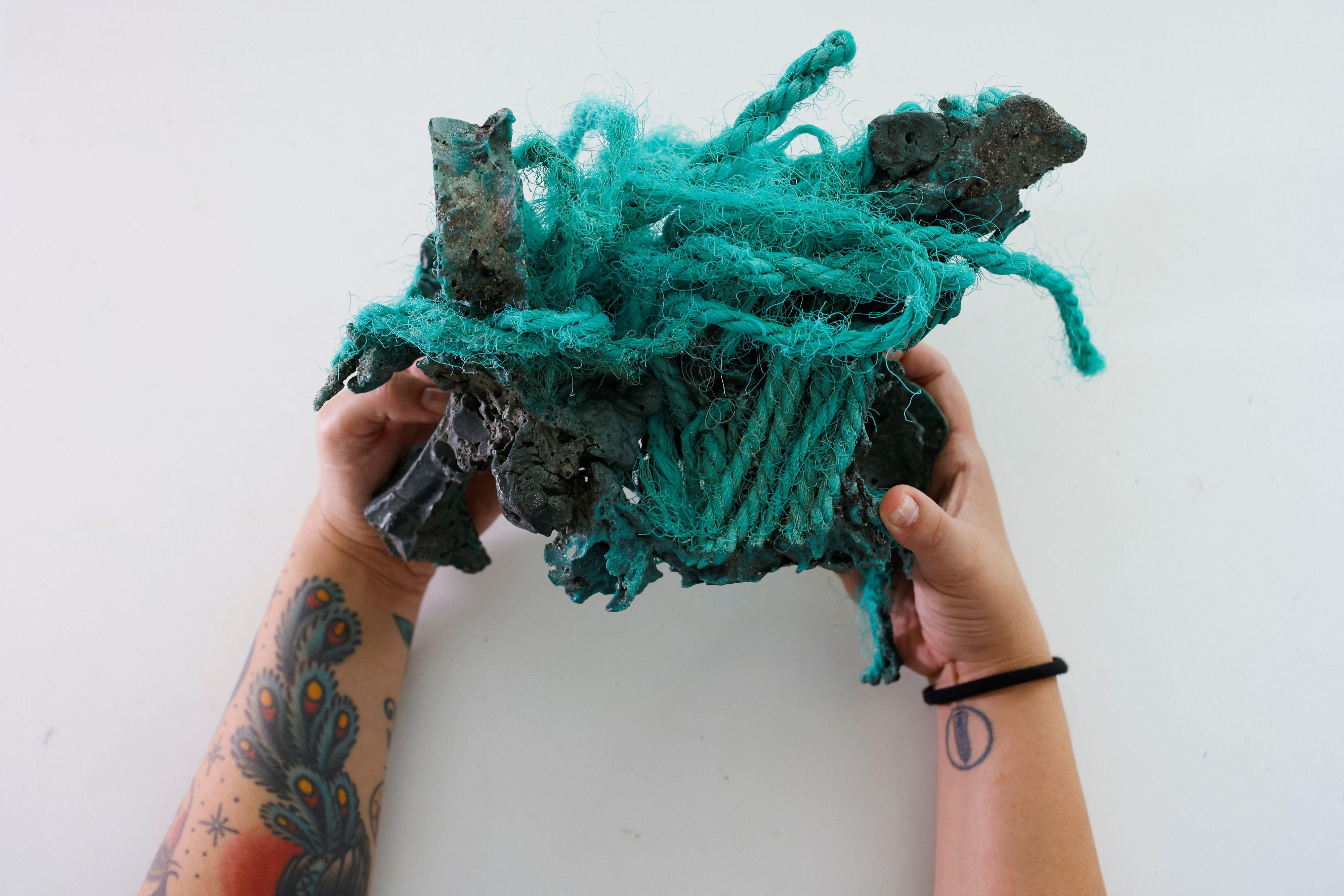 Researcher Fernanda Avelar Santos holds "plastic rocks" found on Trindade Island in the state of Espirito Santo, at the laboratory of the Federal University of Parana, in Curitiba state of Parana, Brazil March 7, 2023. REUTERS/Rodolfo Buhrer