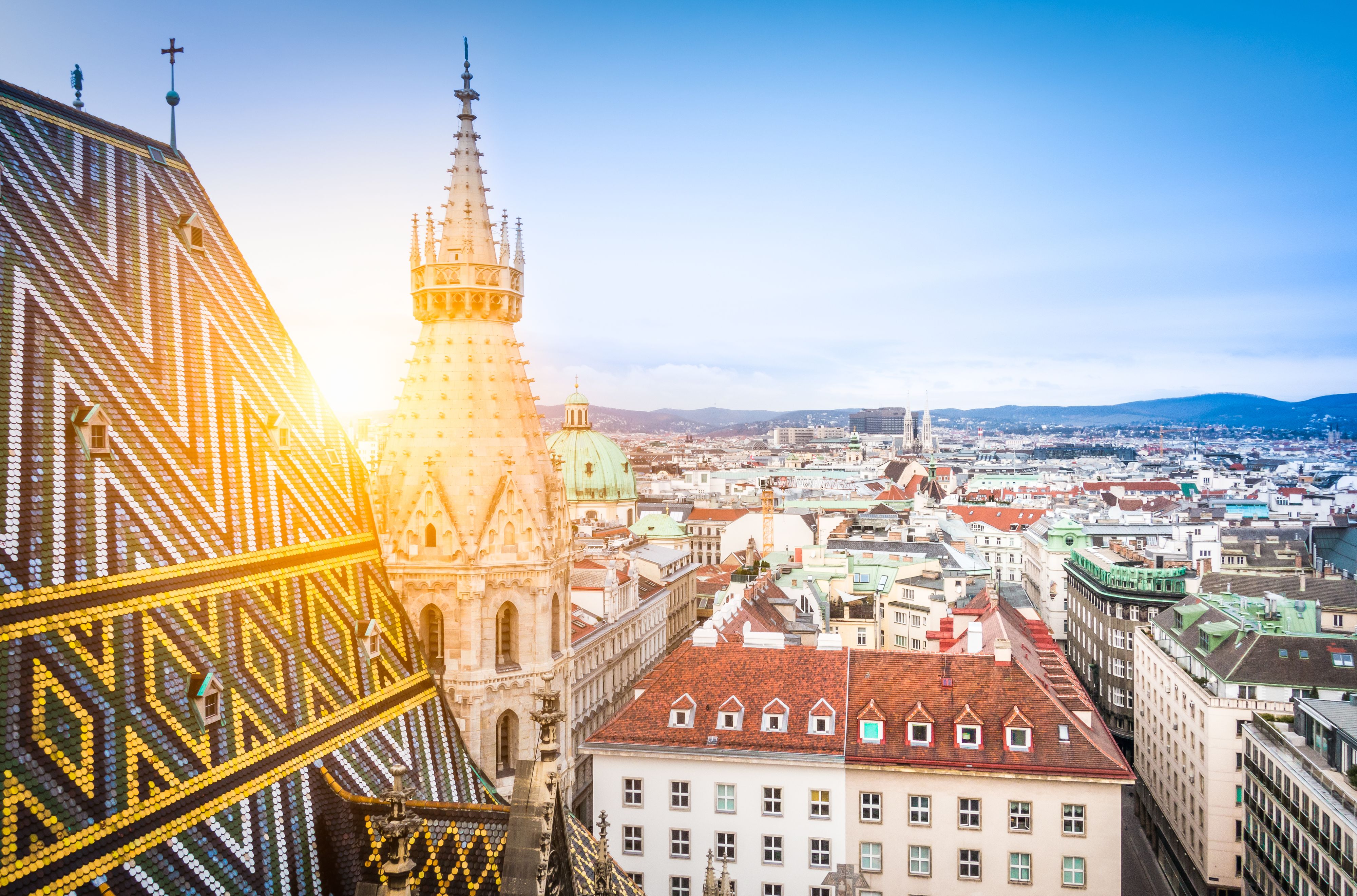 Aerial view over the rooftops of Vienna from the north tower of St. Stephen's Cathedral including the cathedral's famous ornately patterned, richly colored roof created by 230,000 glazed tiles, Austria