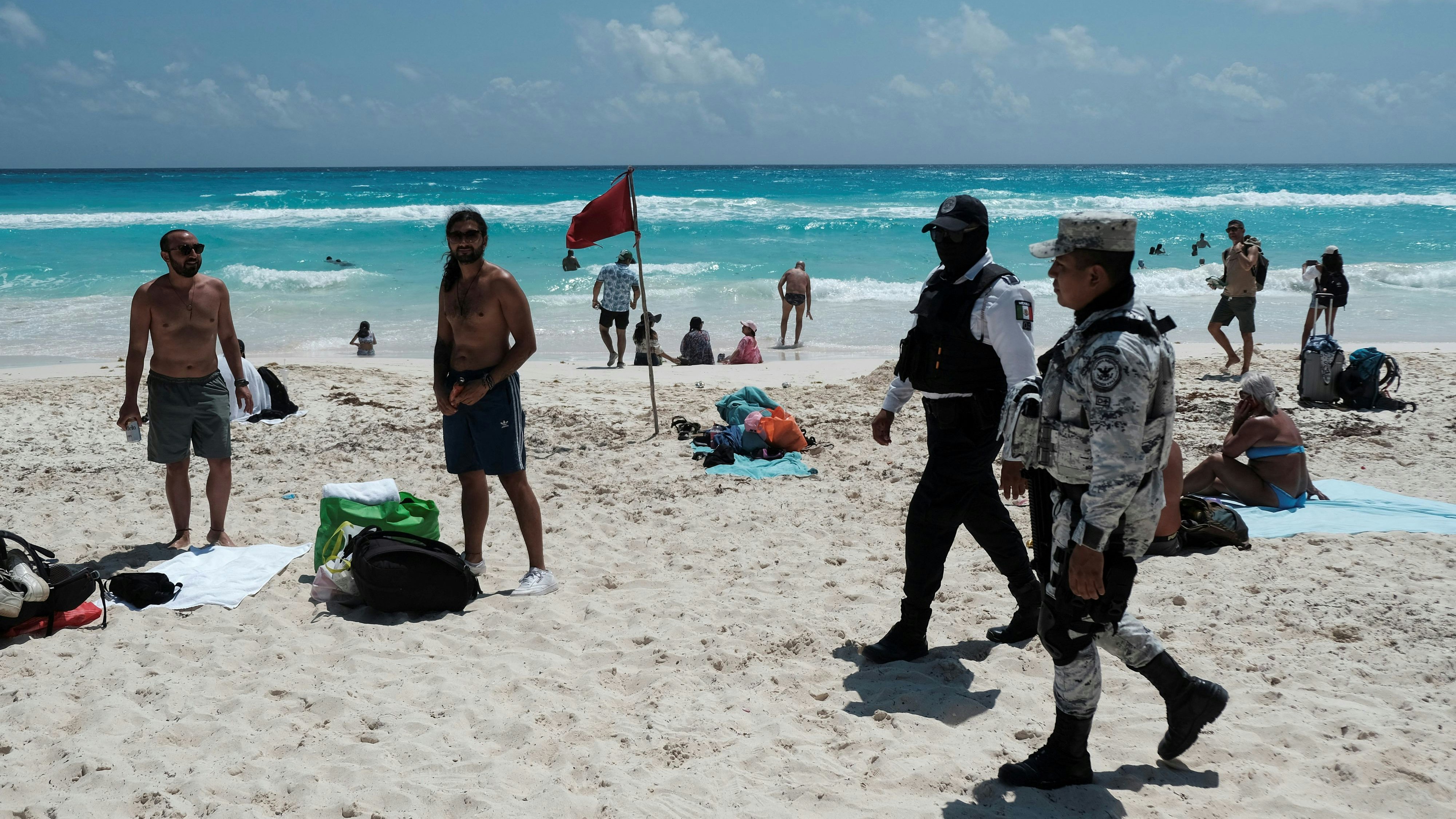 A police officer and a member of the National Guard patrol the Gaviota Azul beach during the beginning of the spring break, in Cancun, Mexico March 18, 2023. REUTERS/Paola Chiomante