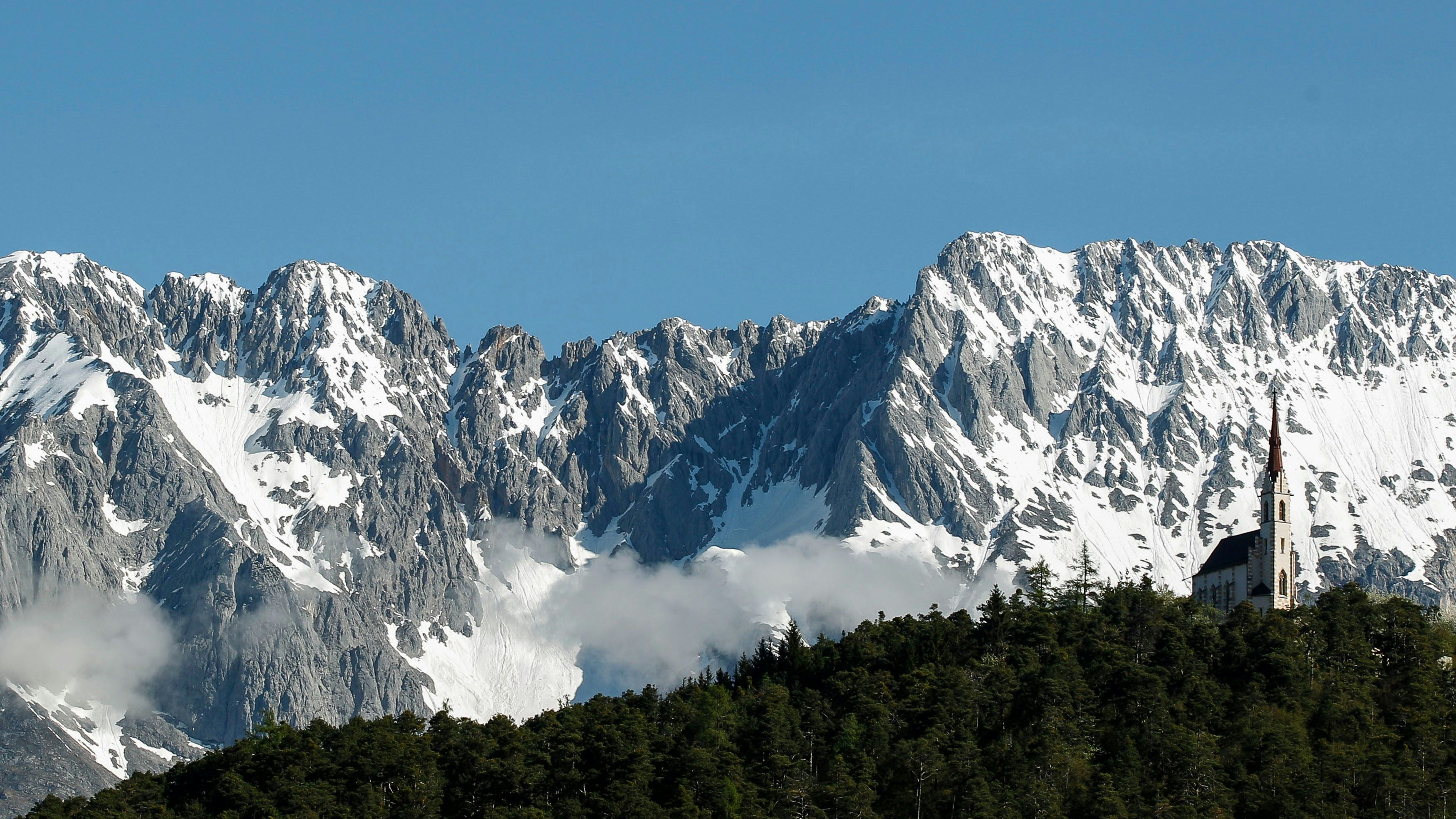 A chapel is seen in front of the snow covered Karwendel mountains on a sunny spring day in the western Austrian village of Silz April 28, 2013 REUTERS/ Dominic Ebenbichler (AUSTRIA - Tags: RELIGION SOCIETY ENVIRONMENT)