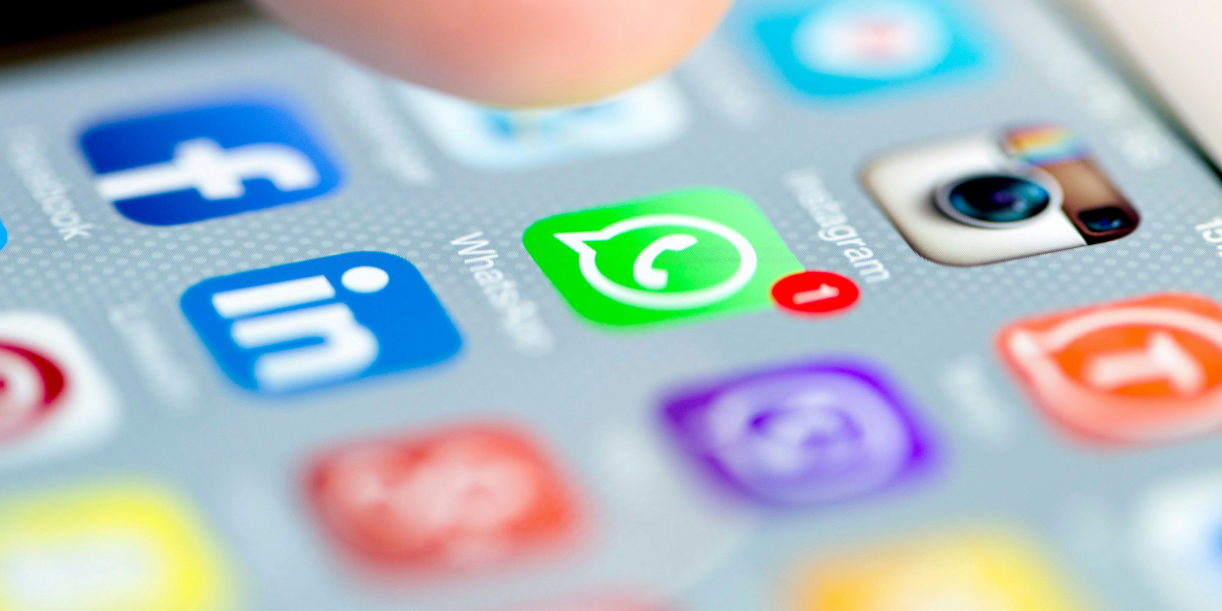 Istanbul, Turkey - September 18, 2015: Apple Iphone 6 screen with social media applications of Whatsapp, Facebook, Instagram, Viber, Linkedin, Tango, Perisfind and Snapchat while a male finger is about to touch on Whatsapp app.