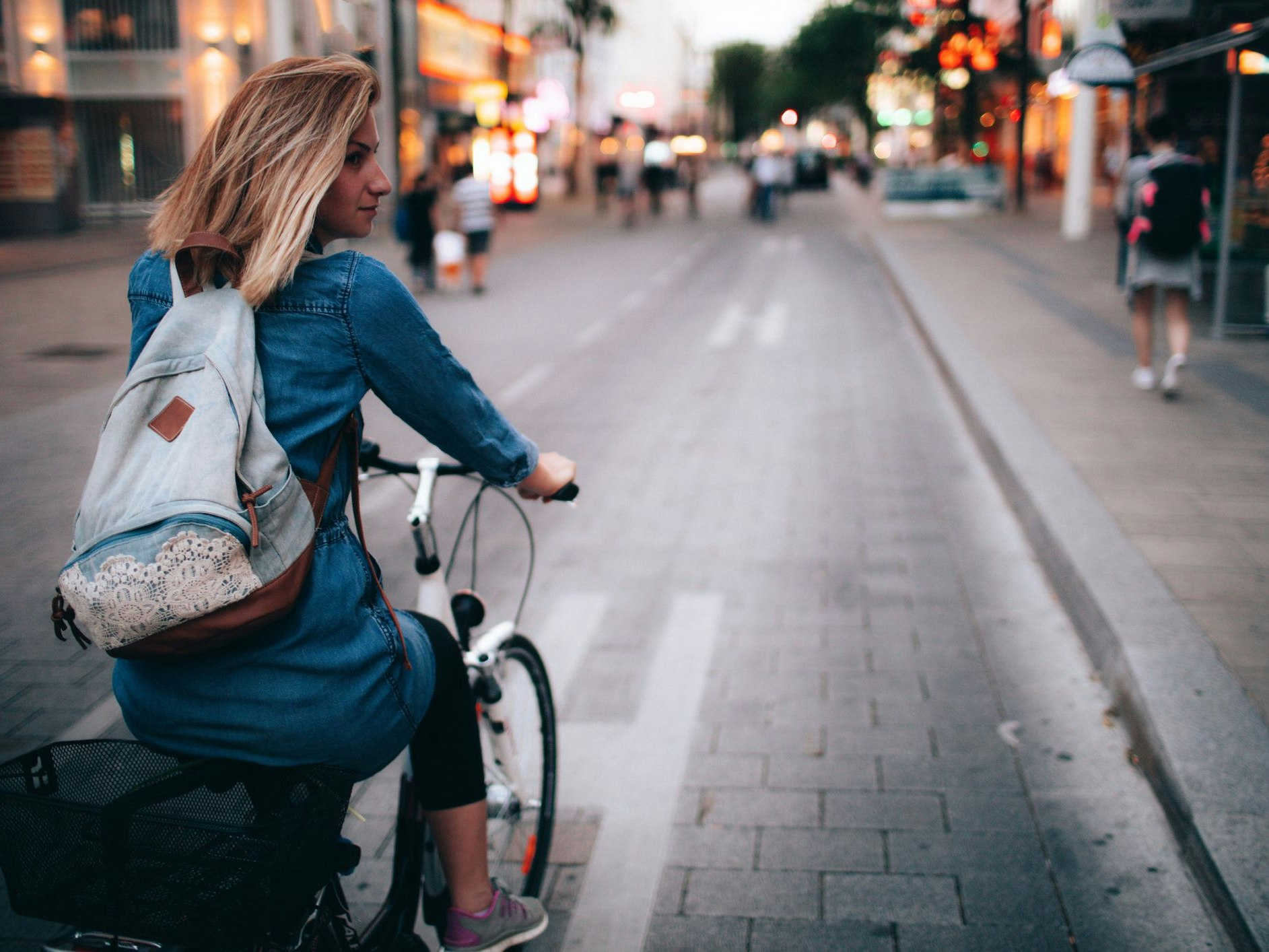 Young woman riding the bicycle around the city 