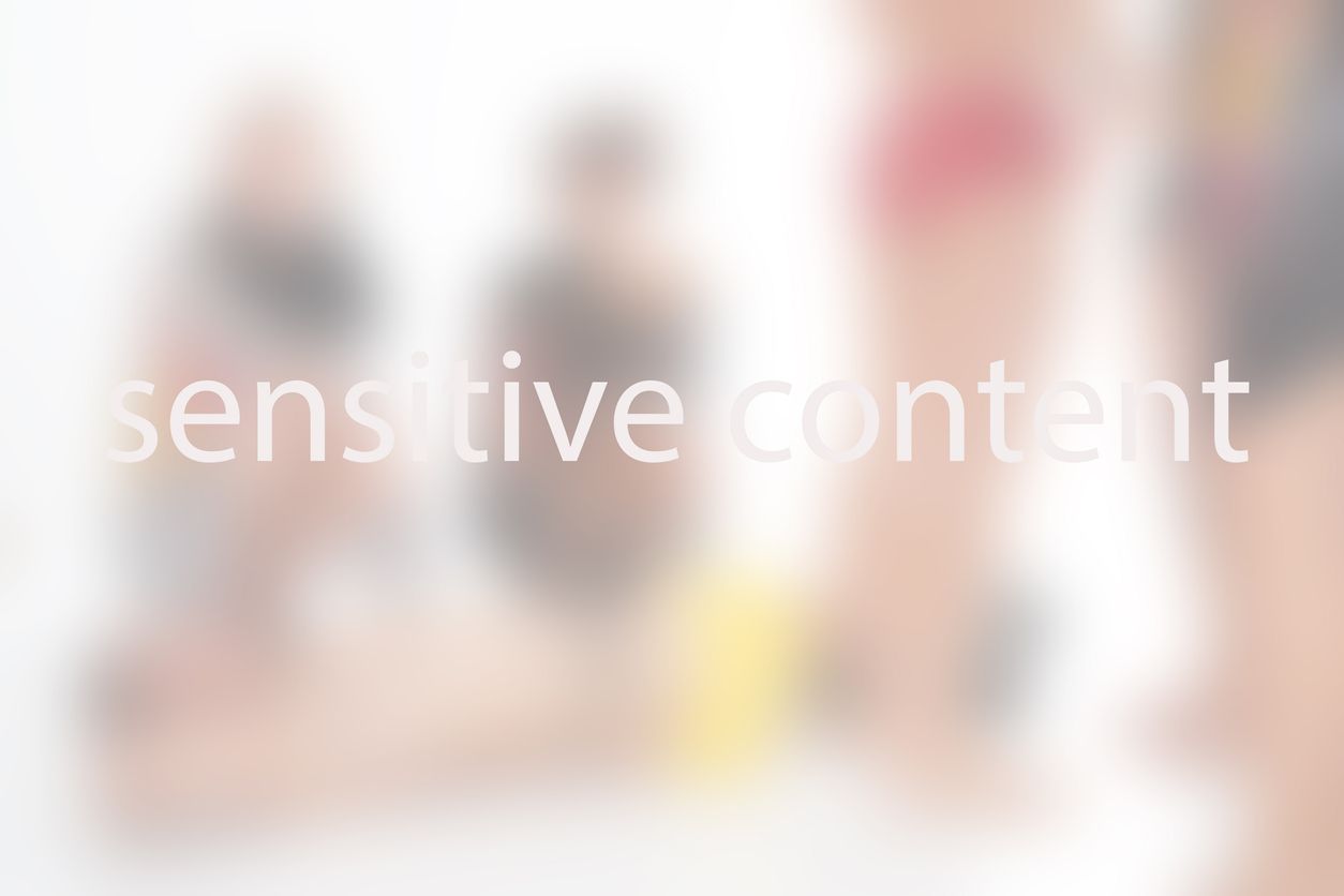 blurry background with a group of people and text sensitive content