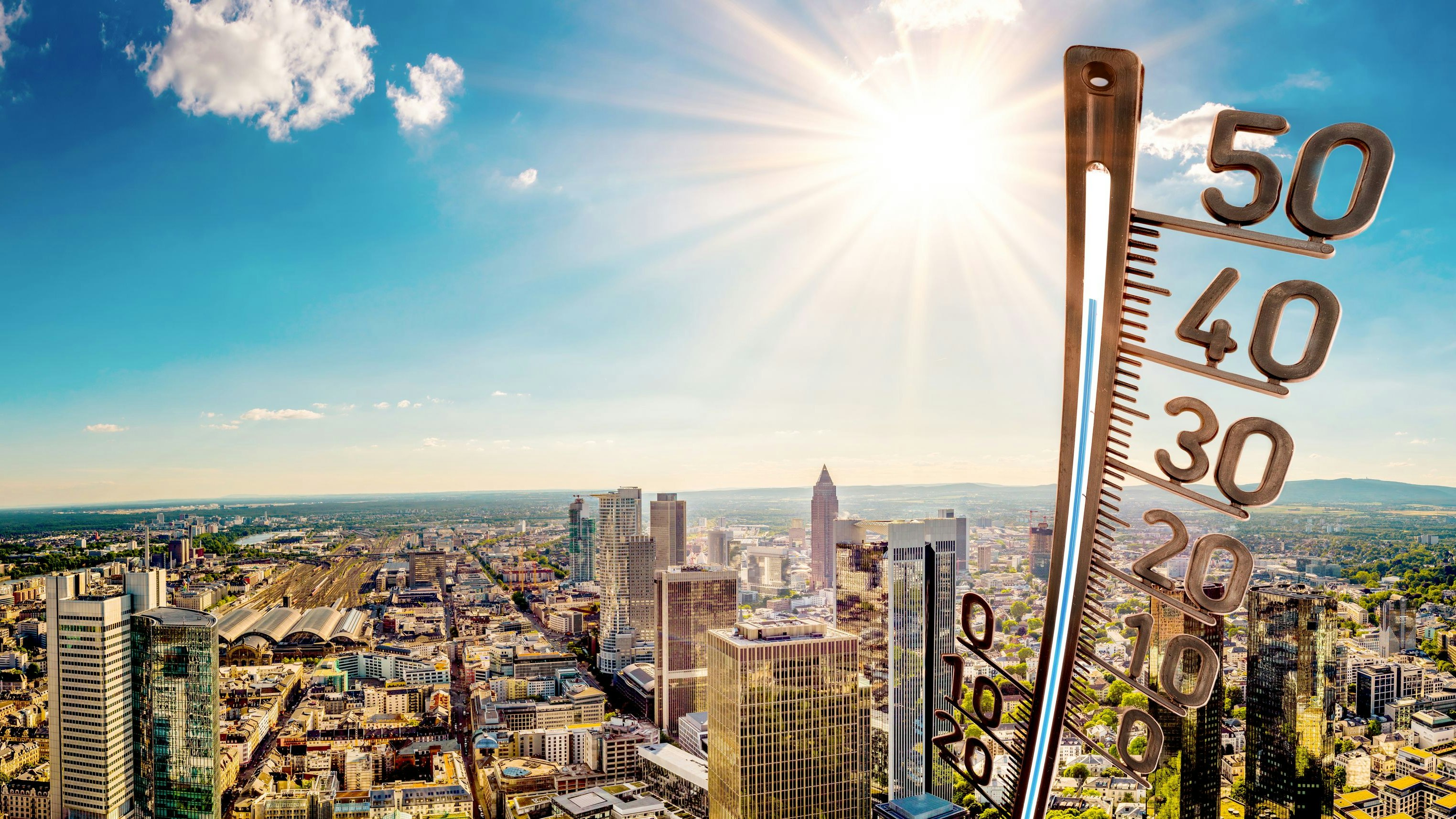 Panorama of Frankfurt am Main on a hot summer day with bright sun and big thermometer