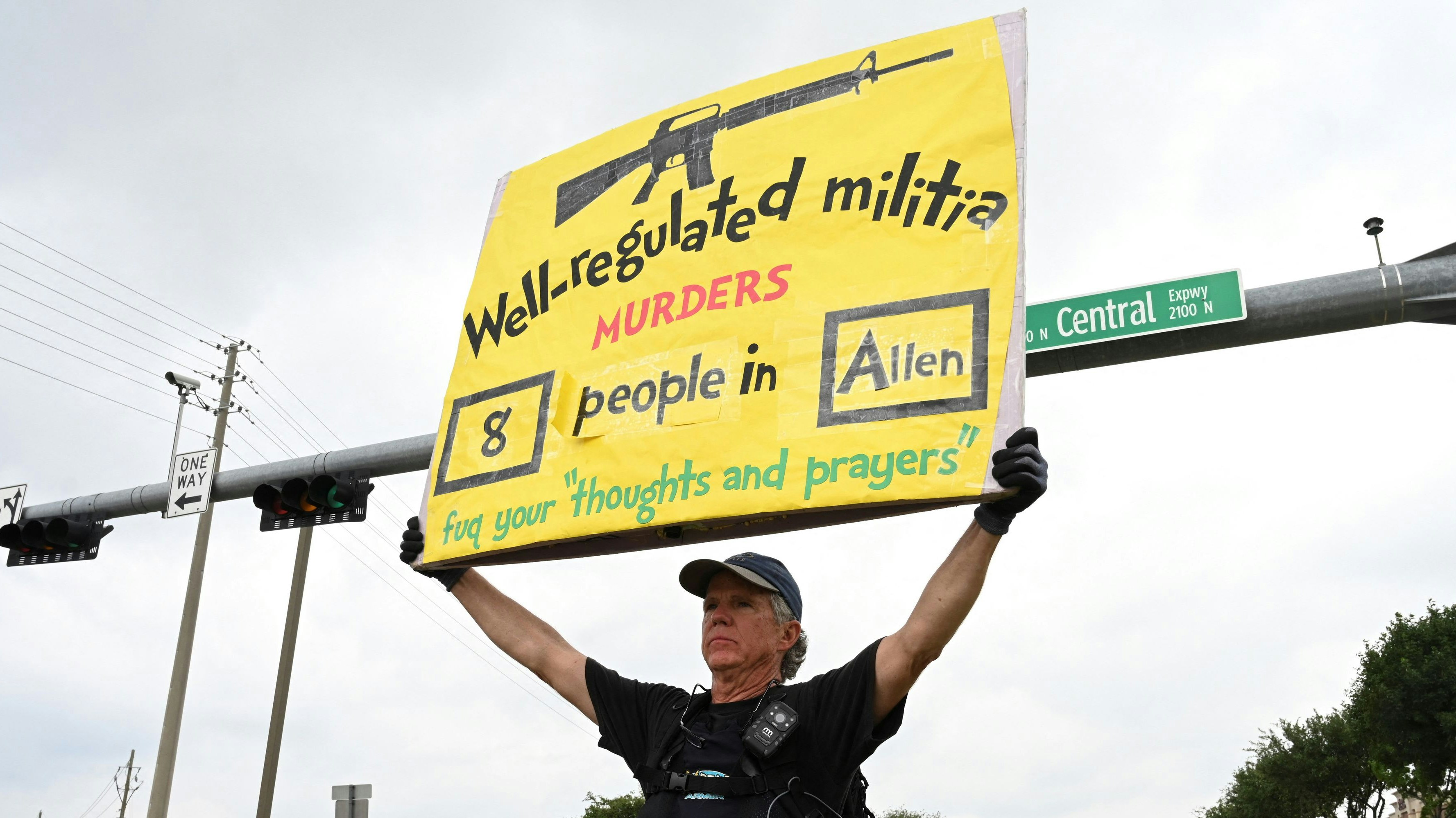 Gordon Jones from the Dallas Fort Worth area holds a sign supporting gun control on a busy intersection by the mall the day after a gunman shot multiple people at the Dallas-area Allen Premium Outlets mall in Allen, Texas, U.S. Gordon says, “supporting gun control legislation lessen theses kind of events”. May 7, 2023. REUTERS/Jeremy Lock 