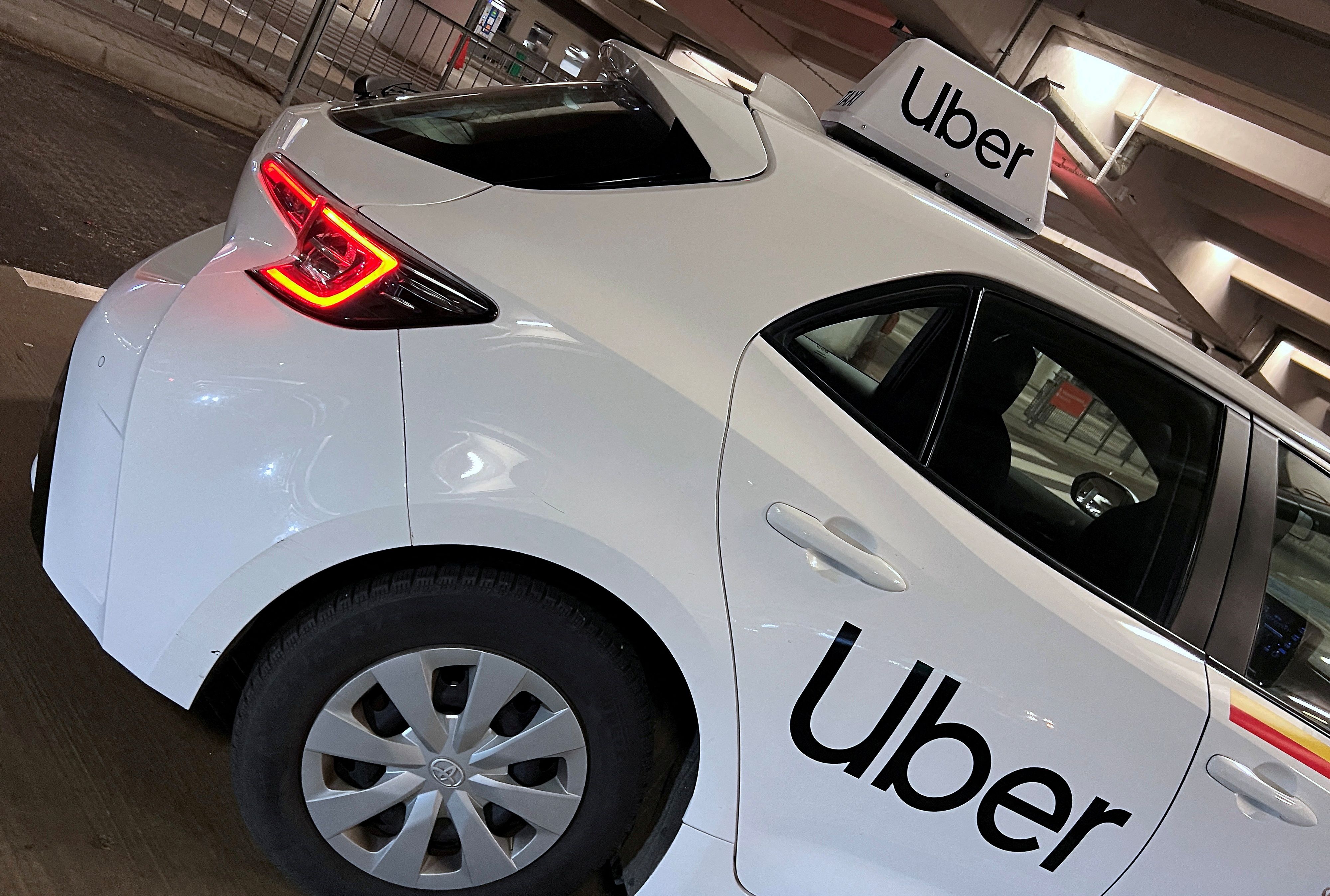 FILE PHOTO: Uber branding is seen on private hire vehicle at Chopin Airport in Warsaw, Poland, March 22, 2023. REUTERS/Toby Melville/File Photo