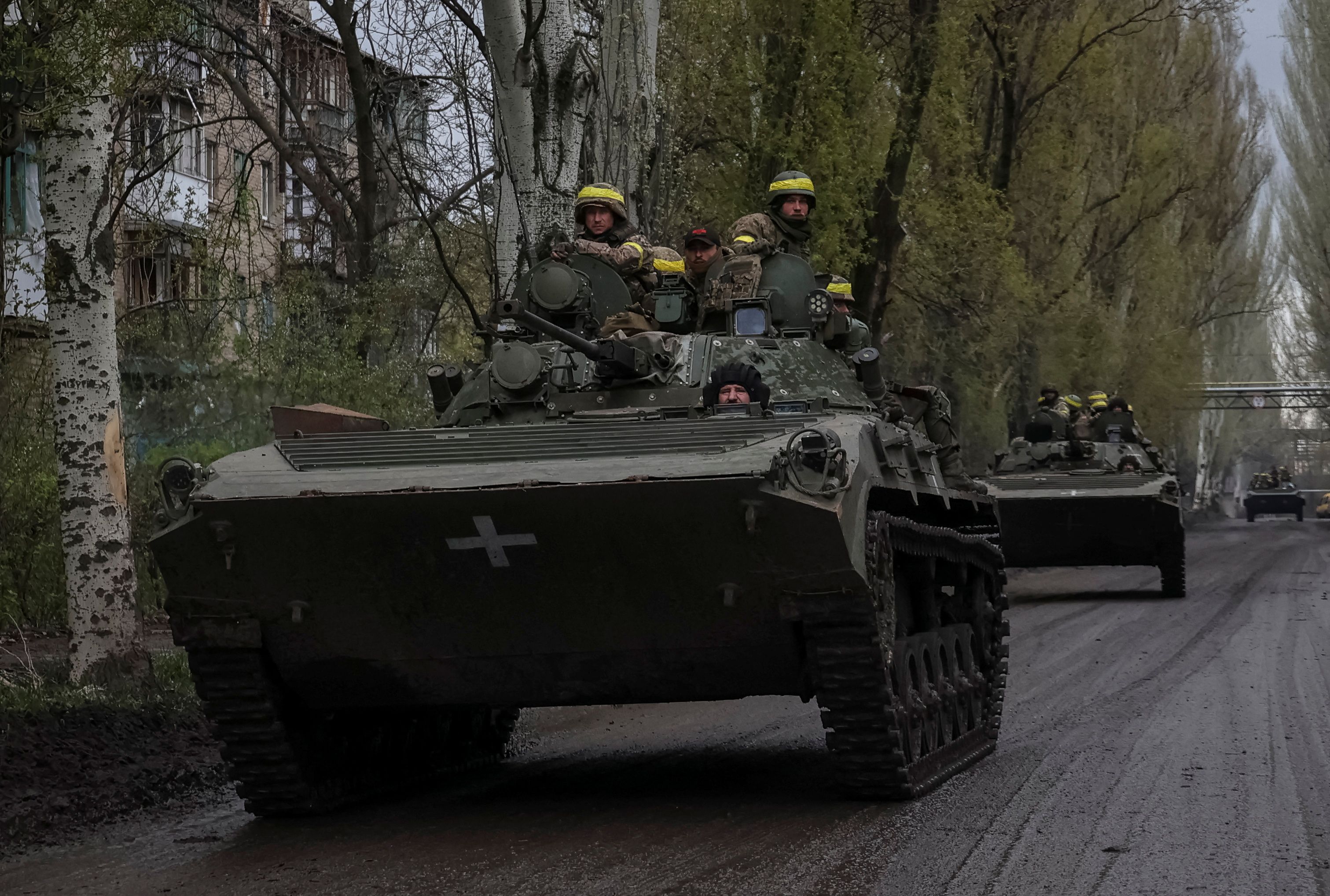 Ukrainian servicemen ride atop a BMP-2 infantry fighting vehicles along a road in the town of Chasiv Yar, amid Russia’s invasion, in Donetsk region, Ukraine April 22, 2023. REUTERS/Sofiia Gatilova
