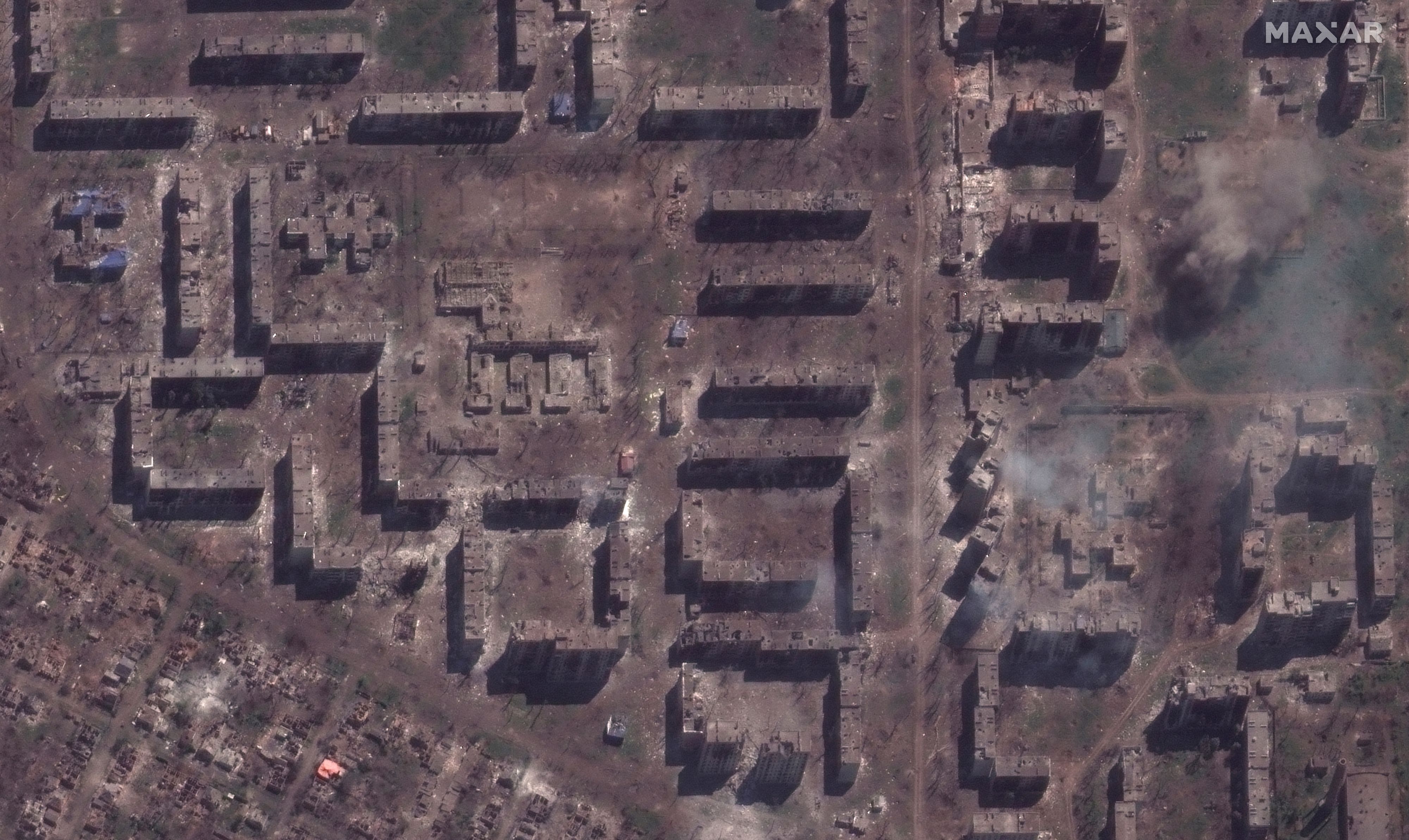 A satellite image shows a damaged school and smoldering apartment buildings in Bakhmut, Ukraine May 15, 2023. Maxar Technologies/Handout via REUTERS THIS IMAGE HAS BEEN SUPPLIED BY A THIRD PARTY. NO RESALES. NO ARCHIVES MANDATORY CREDIT MUST NOT OBSCURE LOGO
