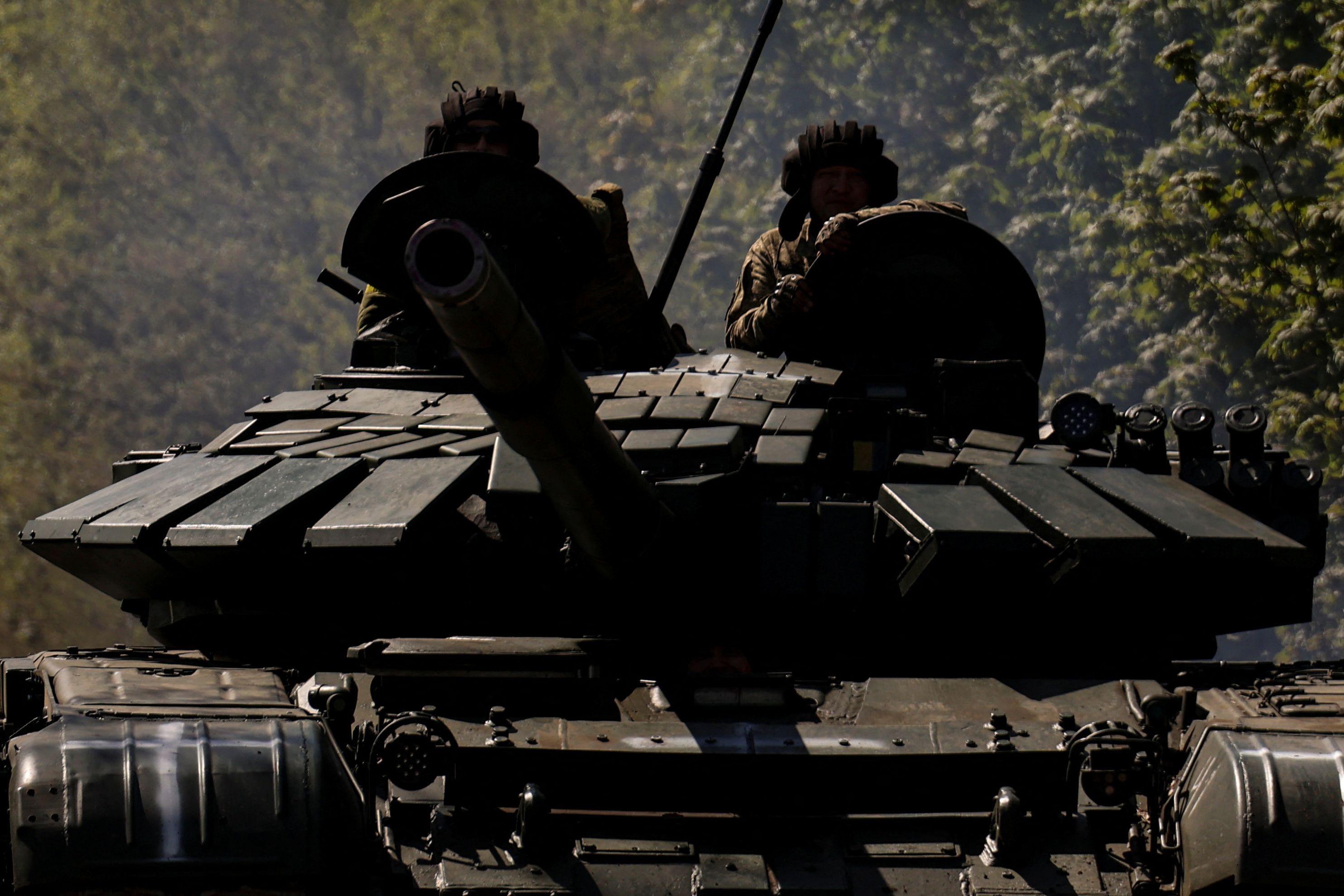 Ukrainian servicemen ride atop of a tank on a road to the frontline town of Bakhmut, amid Russia's attack on Ukraine, in Donetsk region, Ukraine May 12, 2023. REUTERS/Sofiia Gatilova