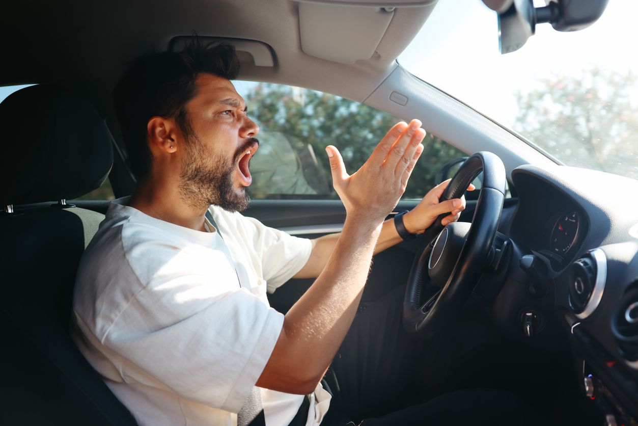 Angry screaming male driver driving car. Driving training and fear of traffic car traffic concept