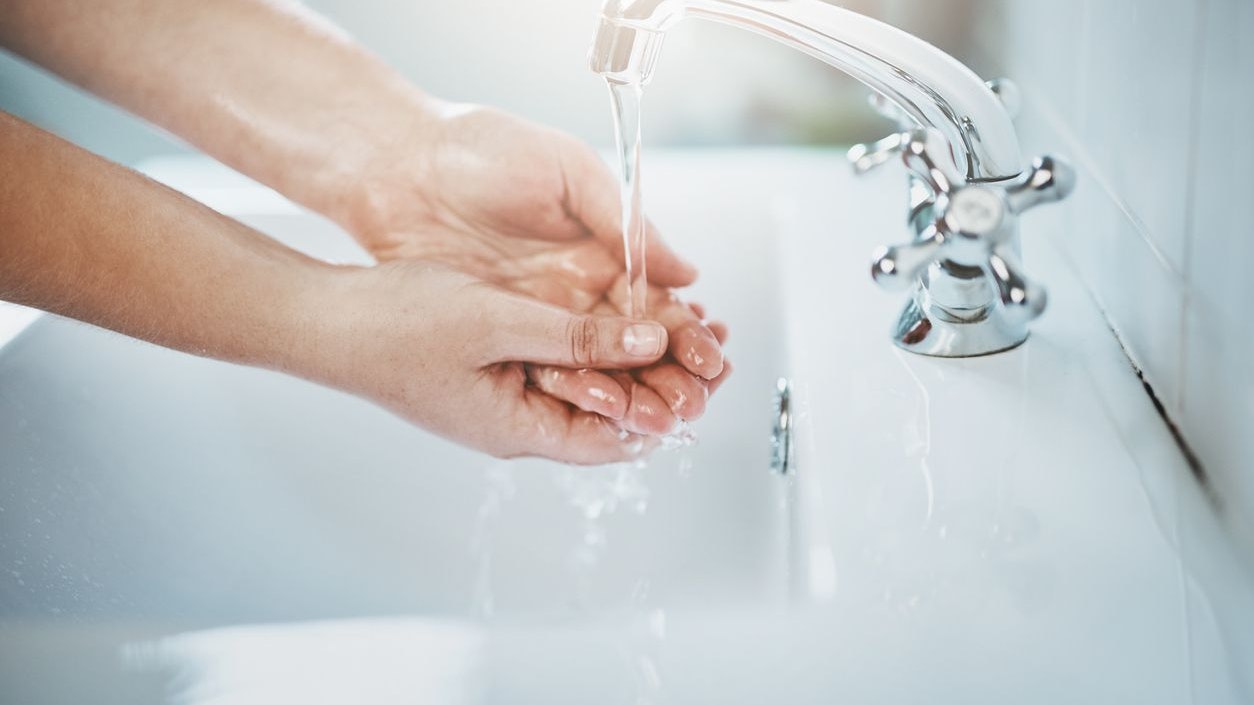 Cropped shot of hands being washed at a tap