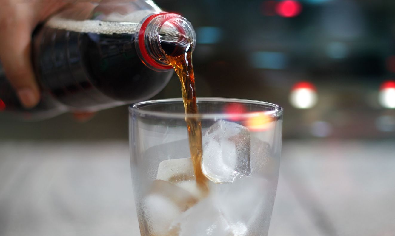 Front view, Pouring cola soda with ice and bubble, cold drink beverage on night background