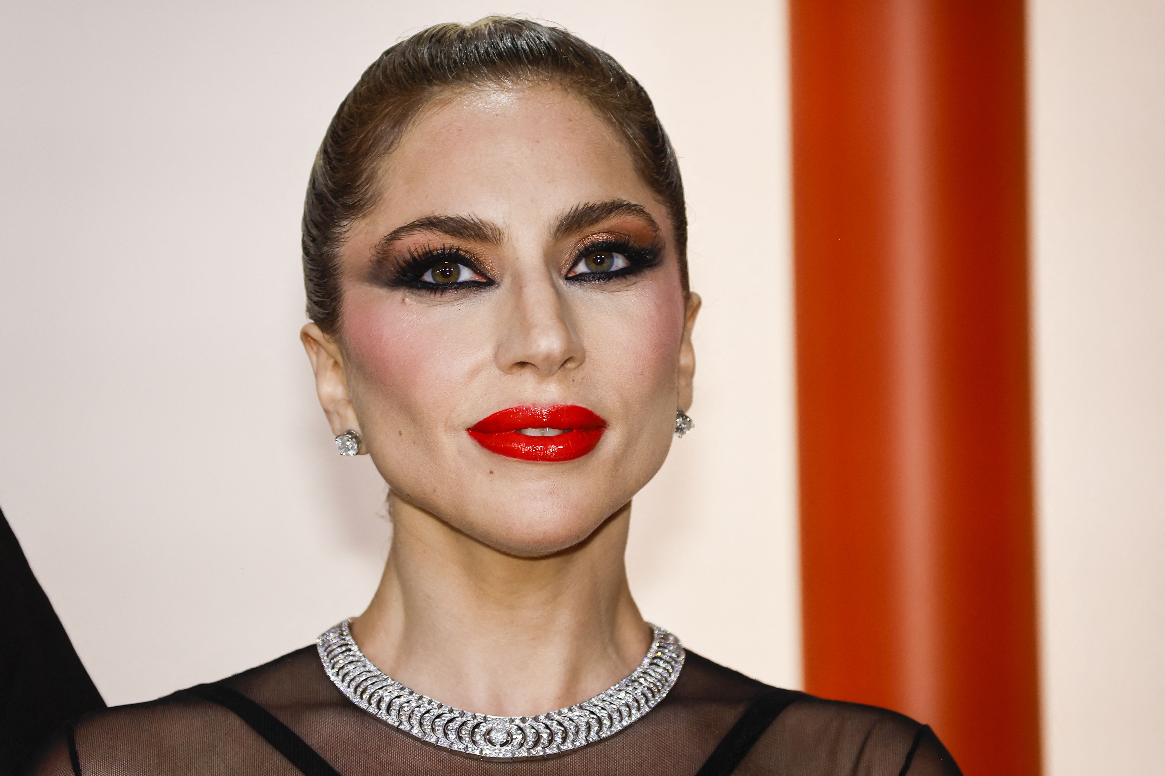 Lady Gaga poses on the champagne-colored red carpet during the Oscars arrivals at the 95th Academy Awards in Hollywood, Los Angeles, California, U.S., March 12, 2023. REUTERS/Eric Gaillard