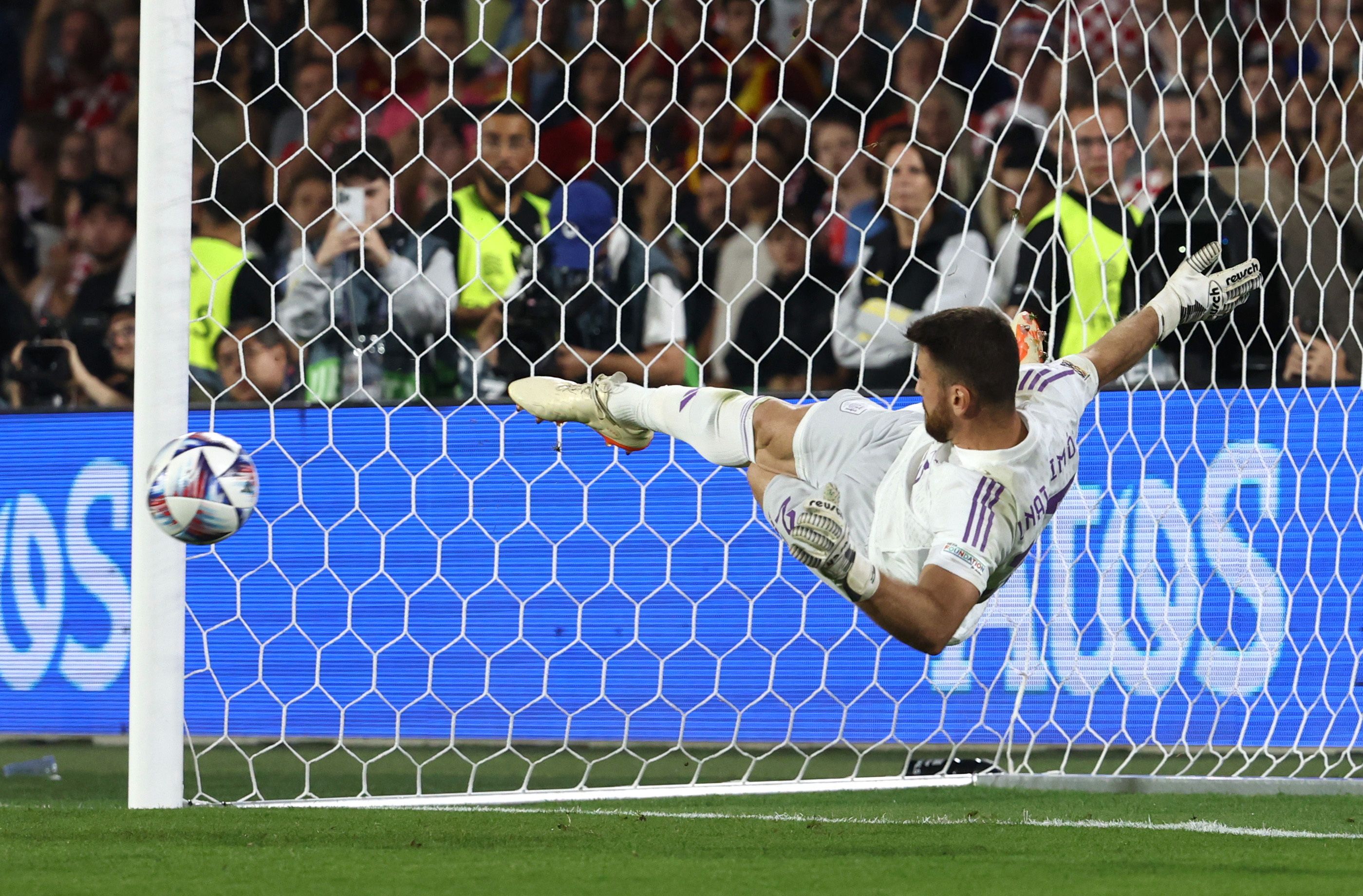 Soccer Football - UEFA Nations League Final - Croatia v Spain - Feyenoord Stadium, Rotterdam, Netherlands - June 18, 2023 Spain's Unai Simon saves a penalty from Croatia's Lovro Majer during the penalty shootout REUTERS/Yves Herman