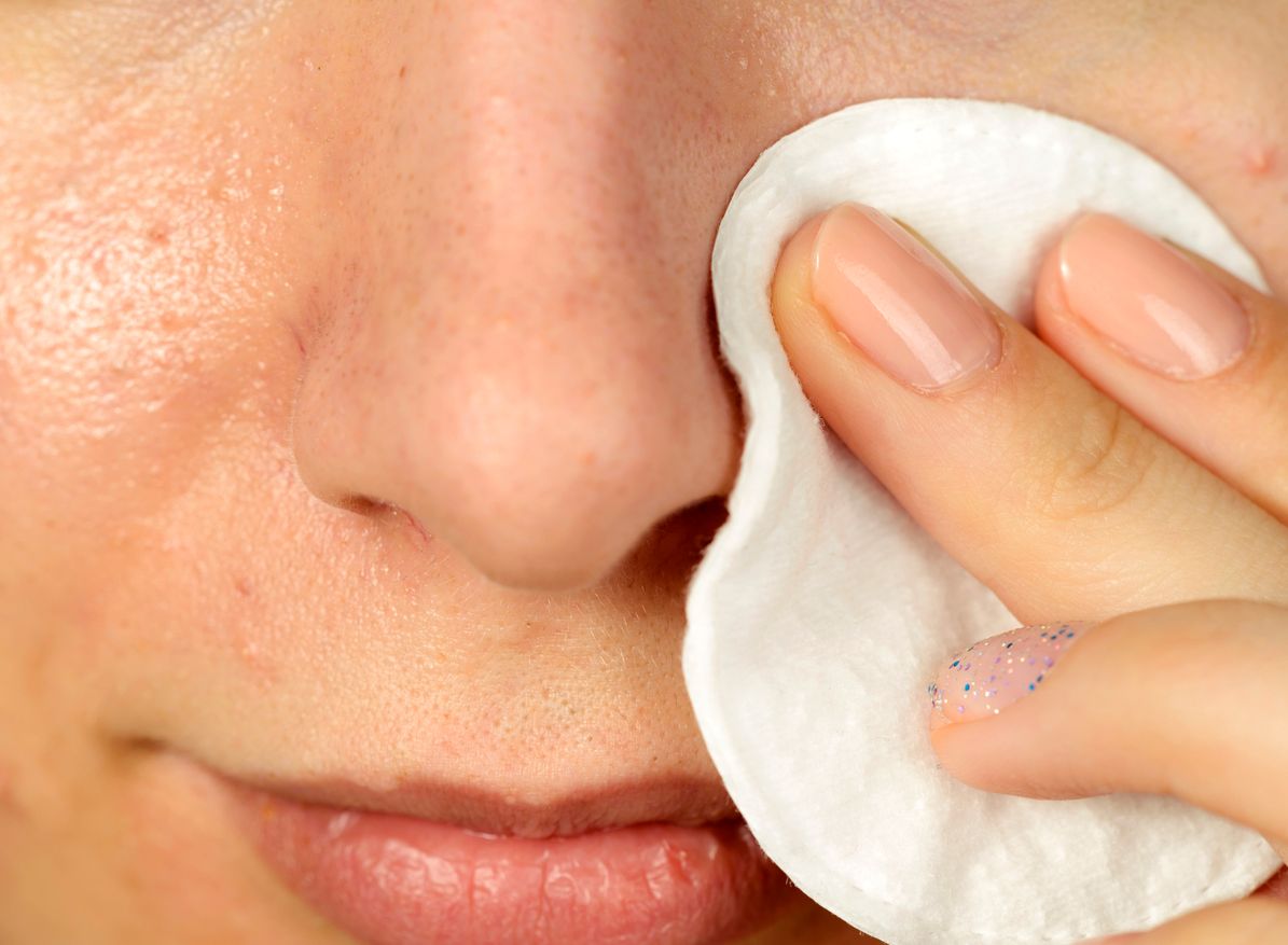 front view of woman portrait cleaning face skin.