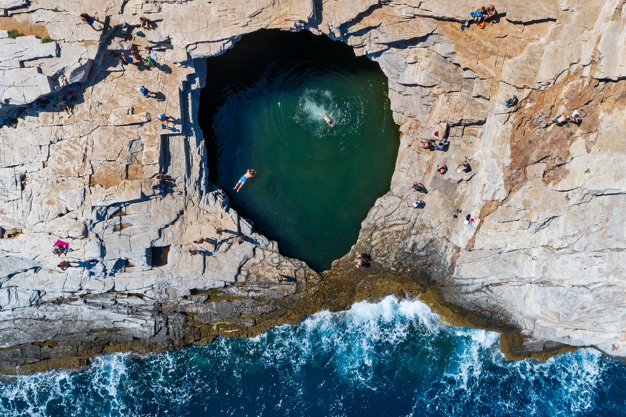 Aerial view of Tourists bathing in the Giola. Giola is a natural pool in Thassos island, Greece
