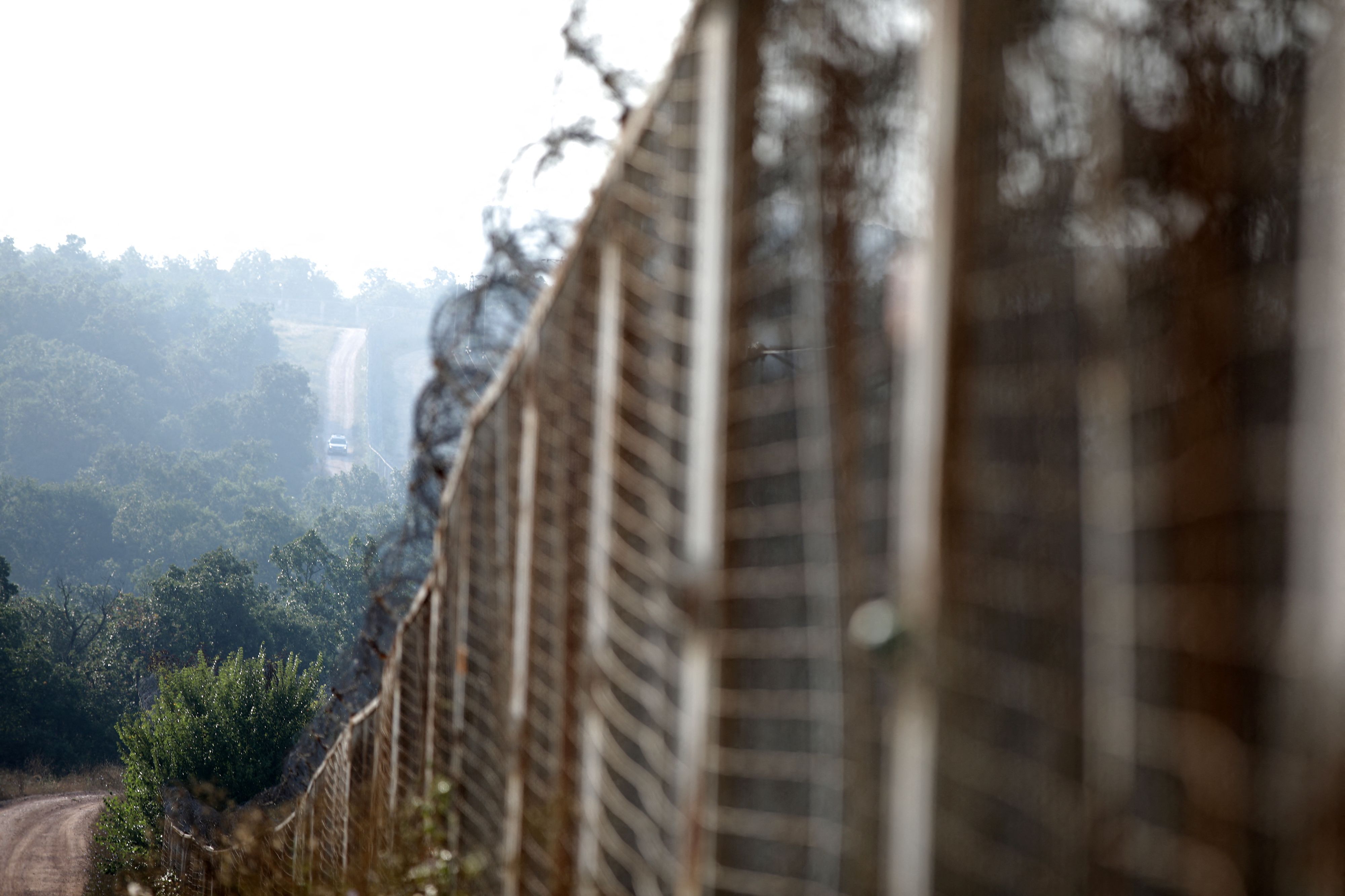 A Bulgarian border police vehicle drives along the fence, built across the Bulgarian-Turkish border, near Elhovo, Bulgaria, September 2, 2022. REUTERS/Stoyan Nenov