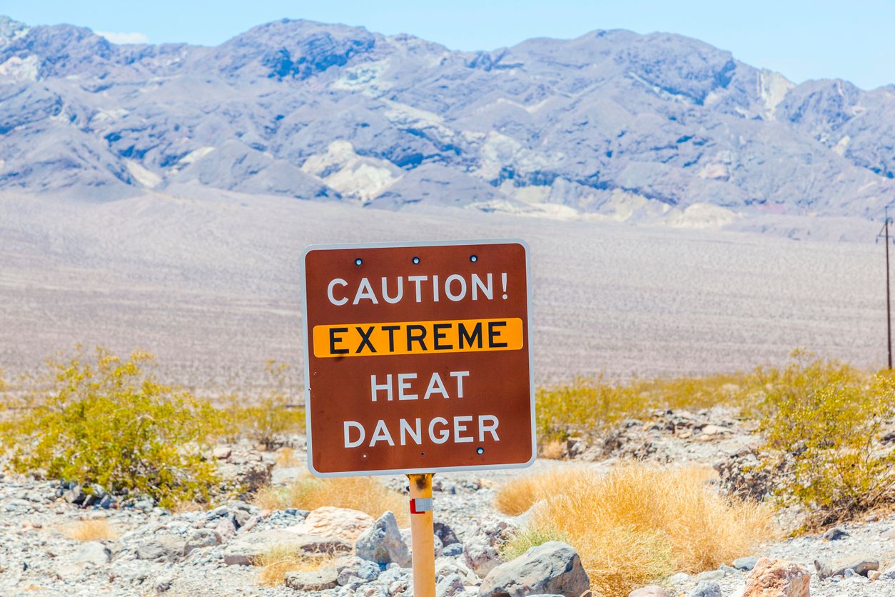 A road sign in Death Valley warning travelers of Caution Extreme Heat Danger