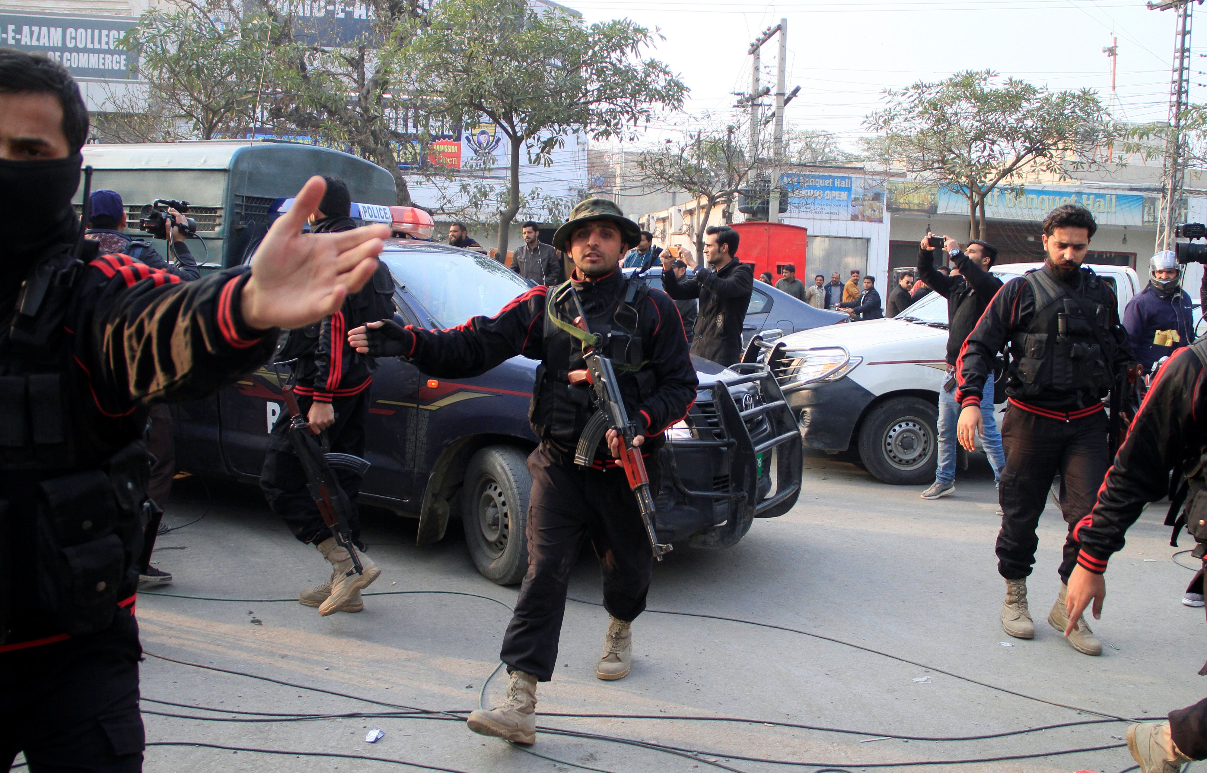 Police clear journalists out of the way for a police van carrying Imran Ali suspected to be a serial killer responsible for the rape and murder of a seven-year-old girl to the anti terrorism court in Lahore, Pakistan January 24, 2018. REUTERS/Mohsin Raza